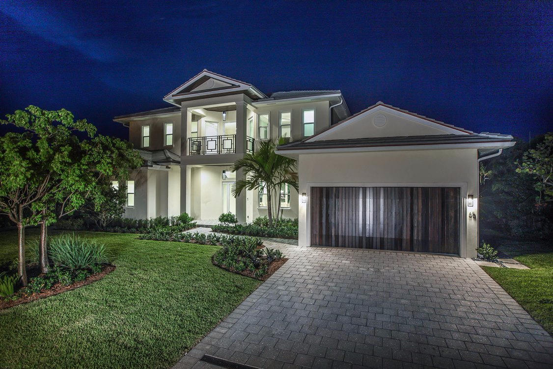 Just completed! Huge waterfront mansion boasting 5,890 total sq. ft. with 4,050 sq. ft. under air. This waterfront estate home in Ocean Ridge on Inlet Cay offers the best of everything for incomparable living only Stephen Varga could offer with this level of quality in his latest custom estate home. If you are looking for spectacular sunrise views along the Spanish River and the superb quality of Varga custom construction, this is the home for you. Only superlatives can begin to describe this home on what is considered by boat owners to be some of the best water in the Ocean Ridge area. From the moment you step from the covered entry into the welcoming foyer graced by beautiful marble floors that flow throughout this custom home, you'll be surrounded by elegance.

Your eyes will take in the expansive living room and the spacious open floor plan and you'll be thrilled with your direct water views seen through soaring, over sized sliding, impact glass doors that lead to the large covered patio.
This 2 story 5 bedroom home provides over 4,000 SF of living space. The large contemporary chef's kitchen design offers a center-island, expansive Quartz countertops, and Thermador appliances including a wine cooler. The beautiful custom wood cabinetry and walk-in pantry are designed for your ease and makes meal preparation a delight for any gourmet cook.
The lower level includes the master suite and second bedroom. The master suite offers fabulous views of the River and very large his & her walk-in closets. The master bath features a beautiful freestanding tub, large 2-person dual-control walk-in shower, his & her vanities, as well as his & her water closets with a bidet in hers.
The junior master suite and two additional bedrooms, each with their own full bath are on the upper level. All bedrooms offer views of the water, and all open to either a covered or open air balcony. In addition, there's a lovely loft living area with river views that opens to the balcony.
Whether it's a yacht, sailboat, power boat or small pleasure craft, this estate home includes 100-feet of water frontage and a 175-foot wide canal to accommodate boats large and small. If lounging by your pool appeals to you, there's a champagne glass Jacuzzi lap pool with sun shelf. If sun and sand is what you desire your very own beach access is only a short walk away.