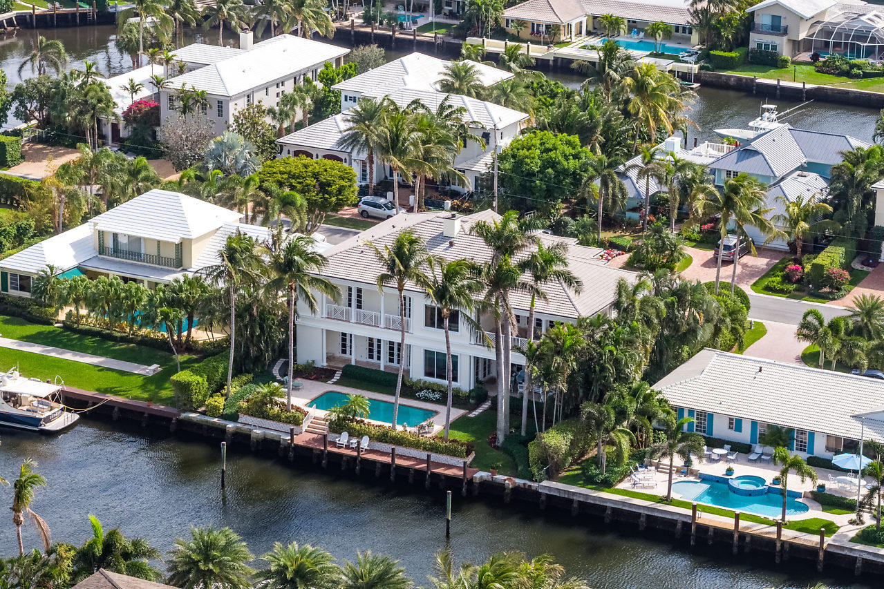 Best buy on the water in Delray Beach, reduced over $1.2M!  A boater's paradise, this fabulous residence prominently located at 1117 Island Dr. in Delray Beach, Fl. only moments to the beach, Atlantic Ave and the inlet has it all. A spacious direct waterfront estate offering over 9,005 total sqft, six bedrooms, seven full baths and two-half baths features luxurious Brazilian wood floors, living room with fireplace, gourmet kitchen complete with butler's pantry, marble countertops, a slate-adorned island, custom cabinetry and professional appliances, dining room, family room with wet bar, elevator, dual laundry rooms, as well as car air-conditioned three-car garage. Architectural details include coffered ceilings, and intricate millwork evoking elements inspired by historic architects Volk and Fatio, Exceptionally maintained, the freshly-painted exterior and interiors portray refined neutral tones, while floor to ceiling impact-glass French doors and windows provide natural light and spectacular water views from every room. The distinguished master suite is well-appointed with his-and-her baths showcasing beautiful tapware and custom marble, dual walk-in closets and French doors leading to an over-sized veranda providing a secluded spot for rest and relaxation.