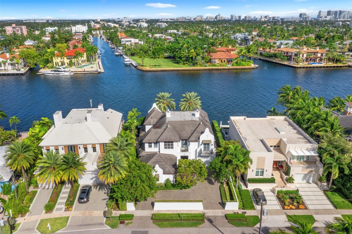 Beauty, elegance, quality, location, & sophistication define this exceptional custom-built waterfront residence. Situated on approx. 101'± of prime waterfront with direct ocean access, the home is located on the tree-lined 7th Street in Rio Vista—one of Fort Lauderdale’s most prestigious neighborhoods. Built in 2010 by Bomar Builders with an uncompromising focus on quality, this 4-bedroom plus gym, 4.2-bath, 3-garage home showcases exceptional craftsmanship throughout. Architectural highlights include vaulted wood-beamed ceilings, refined custom finishes, elegant wood moldings & cabinetry, stone flooring, temperature-controlled wine room, elevator, & automated Armor Screens. The property also features an updated alarm & camera security system, offering enhanced comfort and peace of mind.