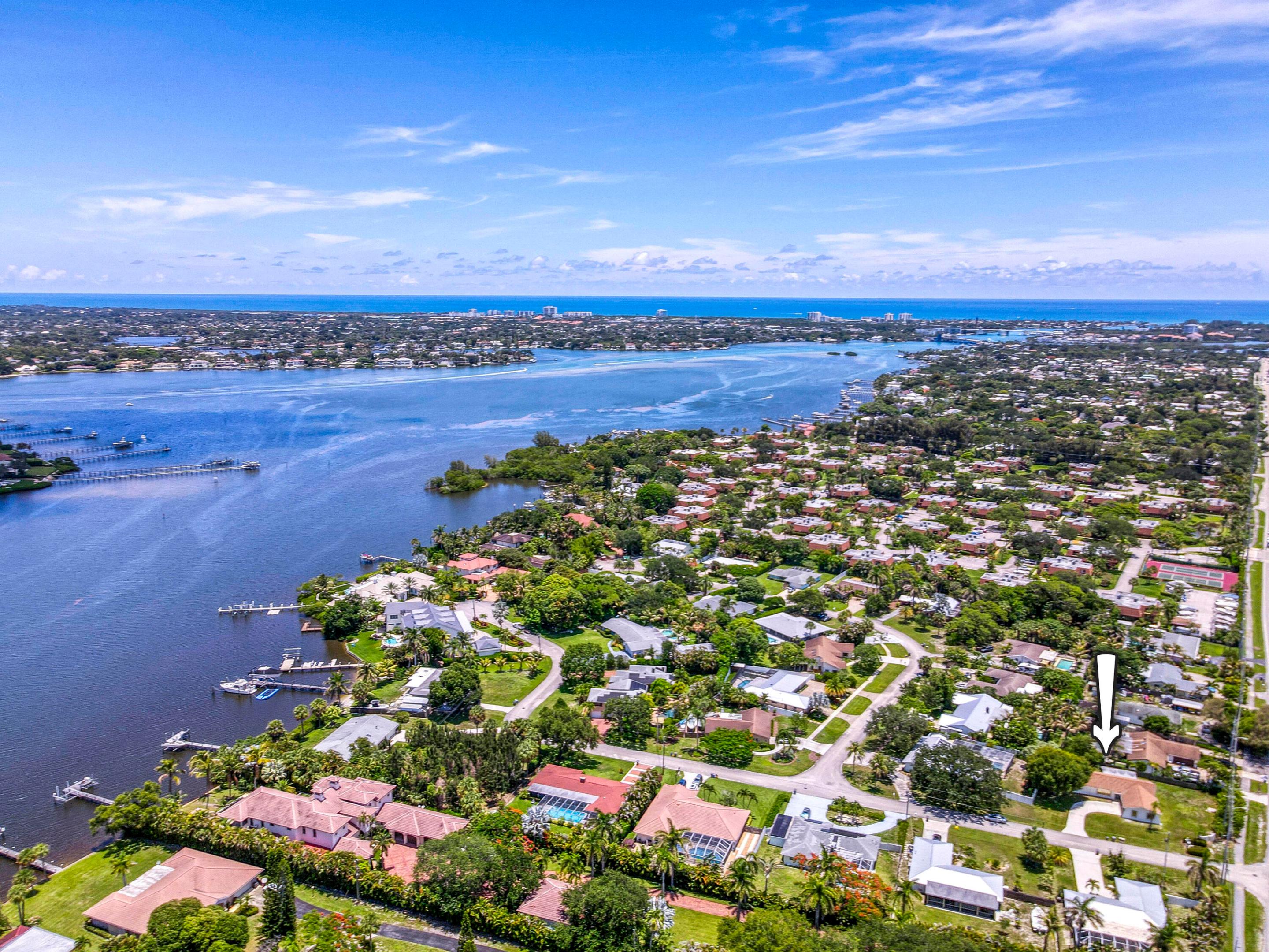 Welcome to Palm Point, a sought-after boat and RV-friendly riverfront community in the heart of Jupiter. Nestled within an intimate 37-home neighborhood adjacent to the Loxahatchee River, Palm Point residents enjoy optional HOA membership (currently just $275 annually) which provides access to the community day dock. Built with solid CBS construction, this easy living single story home offer 3 bedrooms, 2 baths, a 2 car garage and nearly 1,800 sf of living space. Situated on more than a 1/4 acre corner lot, this home boasts an oversized backyard with abundant green space and plenty of room to add a pool or create an outdoor entertaining area. The kitchen and both baths have been beautifully renovated. Notable improvements include fresh exterior and interior paint, vinyl plank flooring, a 2018 roof and a 2022 AC system. Whip up delicious meals in the updated kitchen boasting white shaker cabinetry and quartz countertops. Both bathrooms have been beautifully upgraded with white shaker cabinetry, quartz countertops, porcelain tile in shower and floors. All 3 bedrooms boast new luxury vinyl plank flooring, creating a warm and modern feel throughout. The spacious primary suite offers a relaxing retreat boasting a generous walk-in closet, while two ample sized guest bedrooms provide comfort for family and visitors. Palm Point is conveniently located within close proximity of I-95 and FL's Turnpike, A-rated schools, pristine beaches, shopping, restaurants galore, parks & nature preserves. Live your best life here!