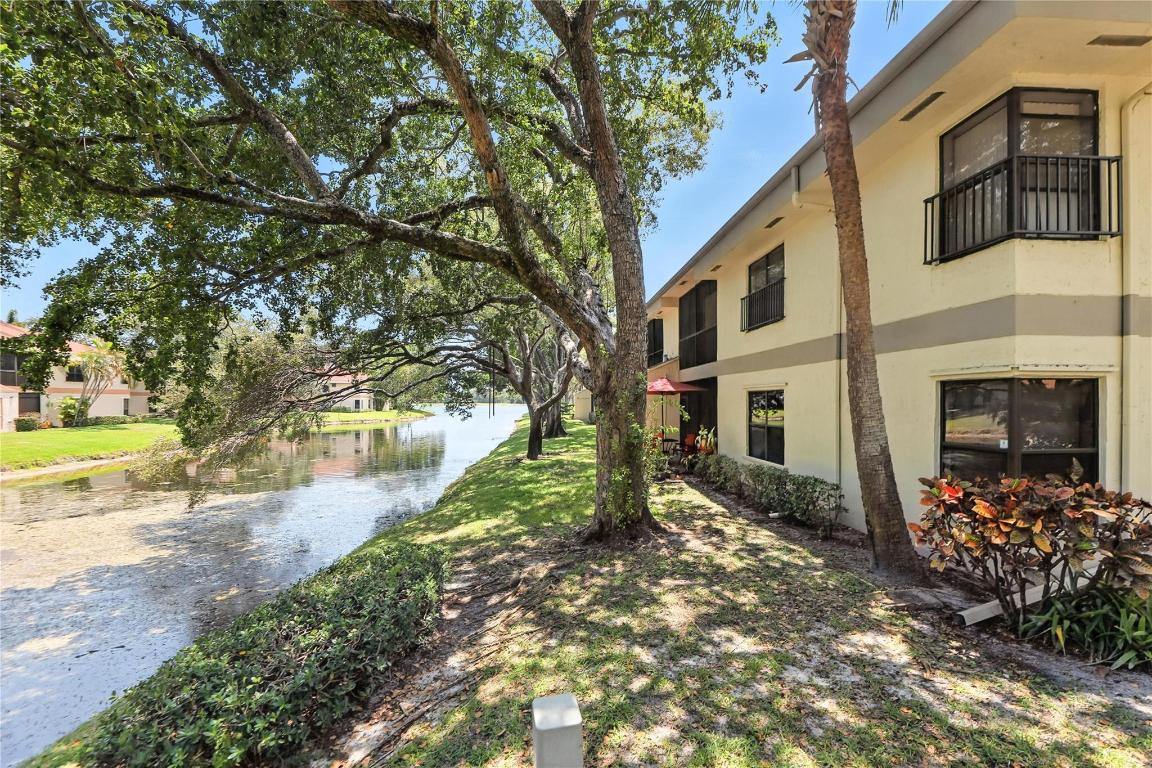 Welcome to Applewood Village IV in Coconut Creek! This 3-bedroom, 2-bathroom condo offers peaceful lake views, a split-bedroom layout, and a screened balcony — all with great bones and plenty of potential. The open living and dining area is filled with natural light, and the eat-in kitchen is functional and ready for your vision. The primary suite includes a walk-in closet and an ensuite bath with separate tub and shower. In-unit laundry, assigned and guest parking, and furniture negotiable for a seamless transition.  The community offers a pool, spa, sauna, tennis, basketball, jogging trails, library, and more — making it a comfortable, amenity-rich place to call home.  A great opportunity for buyers looking to add value, fix/flip, or make it their own in an established community.
