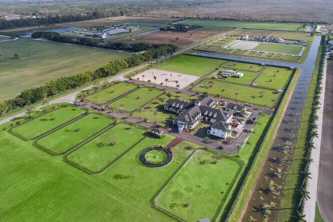 (This is the full 22+ acre estate option. See other listing for 15 acre portion option.) 

Introducing a new offering of the crown jewel of equestrian living - a meticulously refreshed 22+ or 15-acre compound in the prestigious Wellington Preserve. Brace yourself for a breathtaking transformation that redefines luxury and functionality. 5141 Lasso Way is an opportunity that simply cannot be missed. This new offering includes the upgrades and the 22+/15 acre option, and a significant price adjustment.

SELLER FINANCING AND FLEXIBLE CLOSING DATE AVAILABLE!!!! Rejuvenated Beauty and Cutting-Edge Amenities:
Freshly painted interior and exterior for a polished, contemporary aesthetic. Energy-efficient LED lighting throughout, creating a warm and inviting ambiance. State-of-the-art WiFi and cell phone repeaters for seamless connectivity.
Upgraded horse fly spraying system for optimal comfort.
Meticulously landscaped grounds with hurricane-trimmed palm trees and hedges.
World-Class Equestrian Facilities:
Resurfaced arena for prime training and performance.
Newly renovated 16,500 sq. ft. barn with 24 stalls.
Lush grass jumping field for exceptional equine experiences.
Potential for a covered arena or stick and ball field.

Elevated Living and Convenience:
Resurfaced driveway and power-washed roof for a pristine first impression.
Operational front gates with remote cell phone access for enhanced security.
Expertly trimmed hedges for impeccable curb appeal.
This extraordinary equestrian haven is a rare find, redefining the pinnacle of luxury living in Wellington. Seize this opportunity to own a paradise - 
schedule your private tour today.
We are offering it as the full 22.5-acre estate (includes the additional 7-acre grass field), or as the the 15-acre estate (includes all of the equestrian improvements).