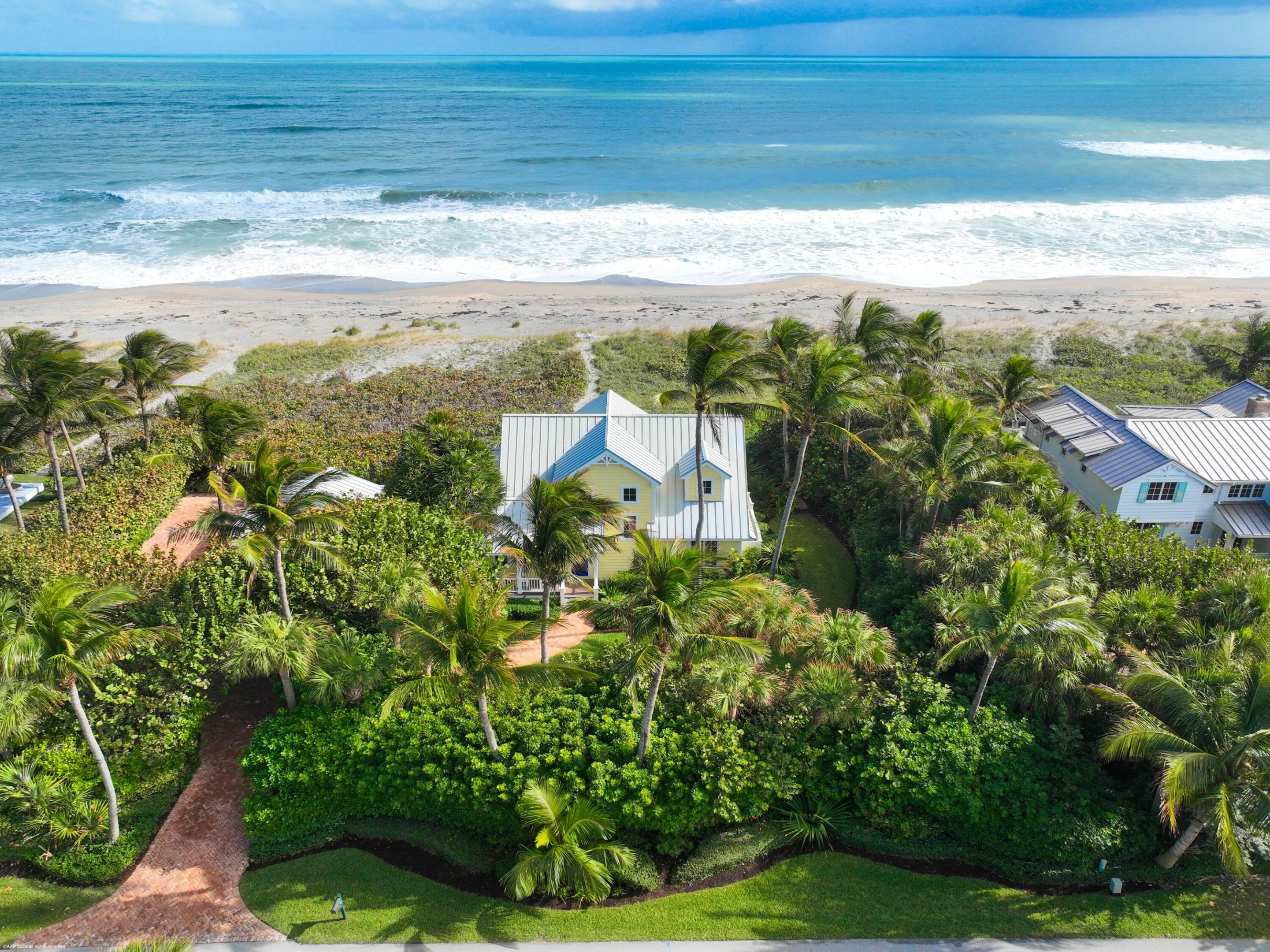 Charming and pristine beach front home with 150' of ocean frontage on coveted Jupiter Island.  Magnificent wide ocean views from the primary suite with French doors leading to a covered balcony. Home features concrete construction with impact windows & doors,  two-car garage, IPE porch & decks, stainless steel appliances including gas stove, tile & hardwood flooring, and outdoor shower. Mature lush tropical landscaping, Chicago brick driveway and paths. Minutes to town, restaurants, shopping, and Palm Beach International Airport.