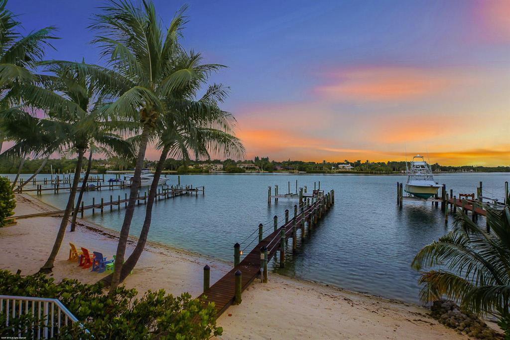 INTRACOASTAL PROPERTY - Over 80' of Direct Intracoastal Frontage with blue water for as far as your eyes can see.  This property is for all water lovers including a sandy white beach.  Custom built in the prestigious Indian Hills this home is perfectly situated with a southeast exposure & has thought in all the details that's sure to impress.  Once entering  the home you'll be swept away with the water views.  The first floor has a large family room that is open to the kitchen, a spacious master suite, a guest bedroom, formal dining room & an office with custom built-ins.   The 2nd floor has 2 additional guest rooms & a sitting area where you will get lost in views.   4 car garage, impact windows, a generator, and a dock for a large vessel - this home is a masterpiece on the Intracoastal.