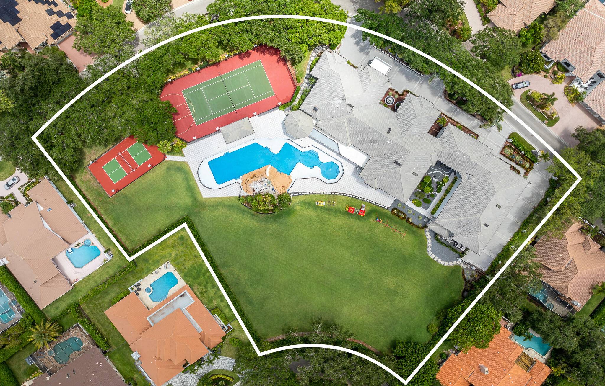 This is an exceptional once in a generation, legacy estate. Situated on a sprawling 2.38-acre lot in the prestigious, guard-gated Eagle Trace community, this estate home offers approximately 21,302 square feet of living space with 9 grand bedrooms and 18 bathrooms. It represents one of the largest and most impressive residences in the area — an unparalleled opportunity for grand-scale living, entertaining, and privacy in South Florida. This magnificent estate combines substantial size, a prime golf community setting, and endless potential for customization. The home blends refined architecture with expansive living areas and resort style amenities that include a 3,200 sqft pool, a sauna & steam room, a regulation size tennis court, a pickleball court, and an indoor racquetball court.  Additional Features for this home include a climate controlled 8-car garage, a dedicated gym, a private movie theatre, a private elevator, a separate detached pool house, a wine/cigar lounge, and a massive upstairs playroom. All the bedrooms are equipped with a dedicated en suite bathroom. The home was thoughtfully built with all CBS construction throughout with the second floor reinforced with all concrete and steel. All the electrical and phone lines are safely routed through protective conduit, as well as a commercial grade 2000 amp electrical supply.