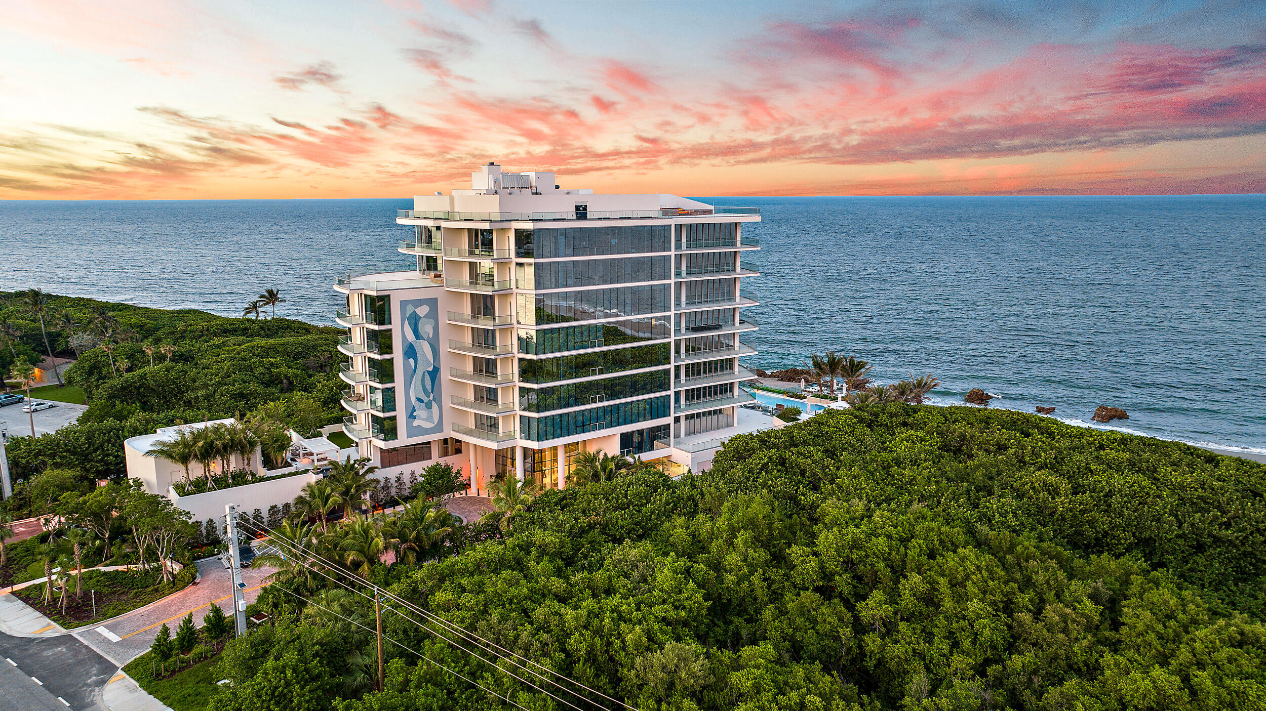 Welcome to SeaGlass on Jupiter Island, an ultra-luxury oceanfront residence offers sweeping Atlantic views and exceptional privacy. With only 21 exclusive residences, SeaGlass offers 24/7 security, resort-style living, and dedicated concierge services.  This refined home features an open layout with floor-to-ceiling windows, marble flooring throughout, 3 ensuite bedrooms, club room, oversized terrace with summer kitchen, and a private 2 car garage. The gourmet kitchen is appointed with top-tier appliances, a Miele wine column, dual dishwashers, and custom Snaidero cabinetry. The primary suite offers terrace access, multiple closets, and his and her baths. Amenities include a 24-hour staffed lobby, infinity-edge pool, day dock, fitness center, yoga lawn, club room, fire pit, and pet areas.