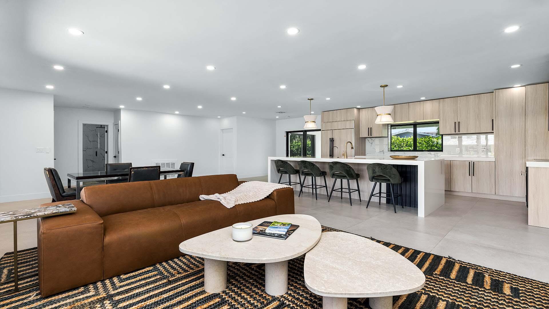 Beautifully renovated and completely move-in ready! This exceptional residence sits on an oversized, fully fenced corner lot in Boca Square, one of Boca Raton's most desirable locations. The open-concept floor plan features a stunning modern kitchen with sleek cabinetry overlooking the spacious family room, while each bedroom offers the luxury of a walk-in closet. The primary suite and kitchen both open to a covered loggia, creating the perfect indoor-outdoor lifestyle overlooking the expansive landscaped backyard. Impact windows and doors, fresh interior paint, updated lighting, custom blinds, reverse osmosis system, and numerous recent upgrades complete this home. Just minutes from A-rated schools, Mizner Park, pristine beaches, shopping, and dining; offering the best of East Boca Raton. 1099 SW 12th Street presents a beautifully renovated residence where timeless design meets everyday comfort. Updated throughout with quality finishes and modern conveniences, this exceptional three-bedroom, three-bathroom home offers an effortless blend of style, functionality, and an inviting indoor-outdoor lifestyle in one of Boca Raton's most desirable neighborhoods.  The heart of the home is a stunning open-concept kitchen featuring sleek contemporary cabinetry, quality finishes, and seamless flow into the spacious family room, creating the perfect setting for both everyday living and entertaining. Designed with a desirable split-bedroom floor plan, the home offers both comfort and privacy. Two of the three bedrooms feature en-suite bathrooms, while the two principal suites each offer spacious walk-in closets with custom built-in organization. The private primary suite enjoys direct access to the covered loggia, creating a peaceful retreat overlooking the beautifully landscaped backyard.  Positioned on an oversized, fully fenced corner lot, the property offers an abundance of green space rarely found at this price point. Mature landscaping and professional landscape lighting enhance the expansive backyard, while the covered outdoor living area extends naturally from both the kitchen and primary suite, embracing South Florida's year-round indoor-outdoor lifestyle.  Ideally located just minutes from Boca Raton's pristine beaches, Mizner Park, premier shopping and dining, top-rated A+ schools, parks, and major commuter routes, this exceptional residence offers a rare opportunity to enjoy a home where every detail has already been thoughtfully considered.  Property Highlights • 3 Bedrooms | 3 Bathrooms • Desirable split-bedroom floor plan • Two en-suite bedrooms • Two walk-in closets with custom built-in organization systems • Completely remodeled with major updates completed within the last four years • Oversized, fully fenced corner lot with expansive green space • North/South exposure for excellent natural light and energy efficiency • Open-concept kitchen with modern cabinetry overlooking the family room • Covered loggia accessible from both the kitchen and primary suite • Impact windows and doors throughout • Fresh interior paint (2026) • Recessed lighting and designer pendant lighting with dimmers (2024) • Automatic custom living room blinds (2024) • Primary roof (2013) • Flat roof resealed (2025) • PVC sewer line (2024) • New washer (2024) • New cooktop (2026) • New gutters (2024) • Professionally updated landscaping with landscape lighting (2024) • Custom built-in garage storage (2024) • Reverse osmosis drinking water system in kitchen (2024) • Custom retractable sliding door screens (2025) • Minutes from A-rated schools, Mizner Park, beaches, premier shopping, dining, and everyday conveniences