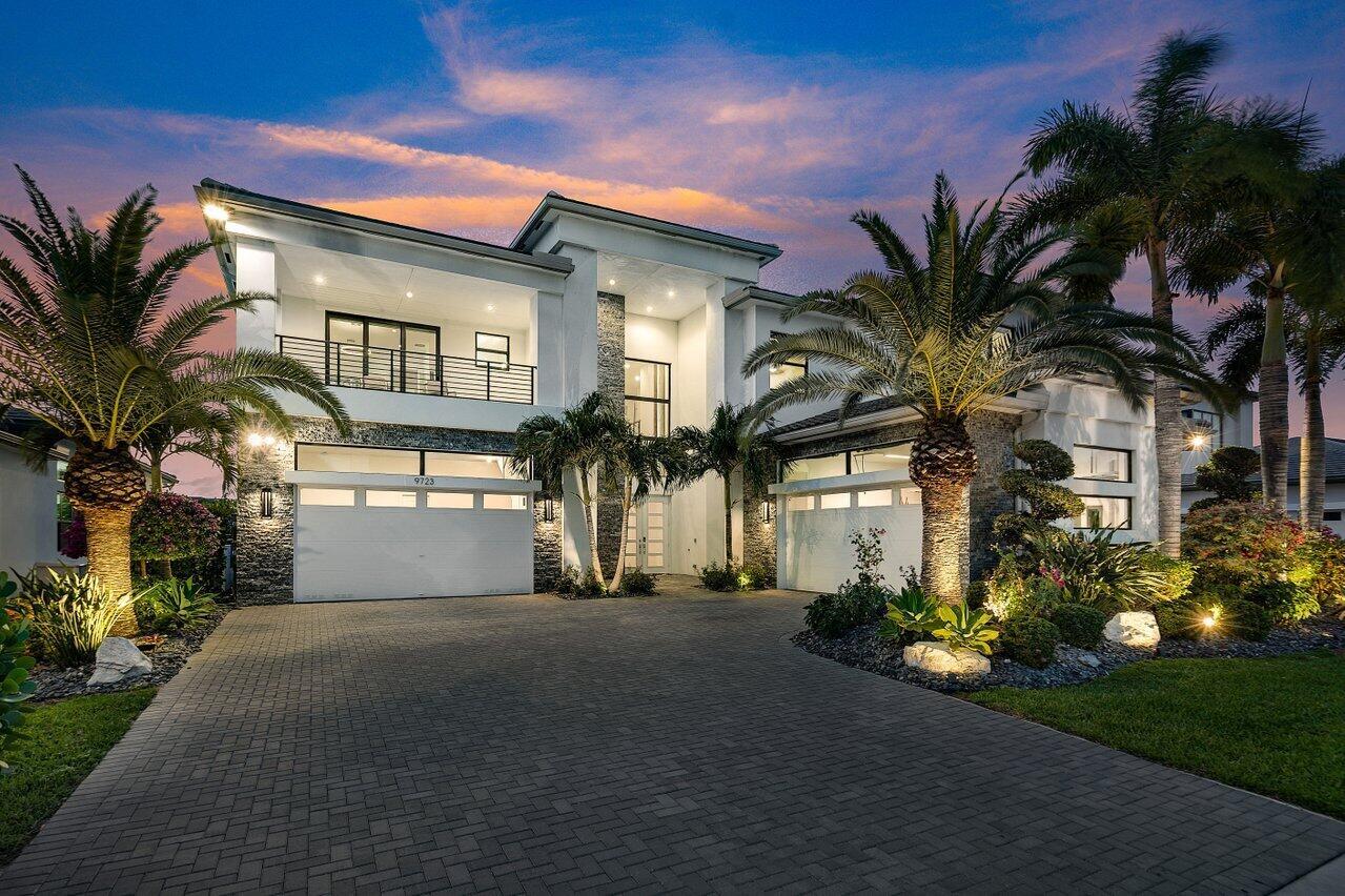 Introducing 9723 Chianti Classico Terrace, a contemporary estate with roughly 6,000 SF under air, in prestigious Boca Bridges. Custom finishes throughout, set on approximately a 1/3 acre private lakefront lot with no rear neighbors! Where luxury meets functionality in every meticulously designed detail. As you enter, you are greeted by a stunning foyer featuring a Fine Art Handcrafted Beveled Arcs 56'' Round Chandelier, effortlessly maintained with an electric motor for easy cleaning and bulb replacement. The heart of the home, the kitchen, boasts premium upgrades including a 48'' additional gas oven and range, complemented by two dishwashers and upgraded cabinets with pull-out drawers. Illuminate your culinary creations with elegant Addis chandeliers and pendants by Crystorama. Entertain in the great room under sophisticated custom carpentry details, which enhances the aesthetic of the foyer, dining room, and kitchen buffet areas. Every detail was considered in the custom movie room theater room featuring theater style stadium seating, motorized blackout shades, complete with the convenience of a sink and mini fridge.

Retreat to the master suite and indulge in the Elk starburst chandelier and wall sconces, epitomizing opulence. The master bath is a sanctuary with floor-to-ceiling tile, an upgraded shower system featuring four body showers, an overhead rain shower, and a wand.

Outdoors, luxuriate in the summer kitchen with a mini fridge and stainless steel backdrop. The pool area, equipped with a chiller, heater, and hot tub, ensures year-round enjoyment. Motorized screens provide comfort and privacy, while professional landscaping and luxurious landscape lighting elevate the ambiance.

Additional upgrades include a full-house water filtration system, a 30kw gas generator, and ring security cameras ensuring peace of mind. The home also features upgraded modern solid wood doors, travertine patio tiles, and a toad fence for added security.

This home is a masterpiece of design and innovation, offering the ultimate in luxury living. Don't miss the opportunity to make it yours!

Boca Bridges is an upscale, gated community that promises an unparalleled living experience. The centerpiece of this luxurious enclave is the magnificent 27,000 square-foot clubhouse, providing residents with access to a resort-style pool and a full-service gourmet restaurant and bar.

For those seeking an active lifestyle, there is a state-of-the-art fitness center, offering a range of exercise classes. The community has 7 tennis courts, 4 pickle-ball courts, both indoor and outdoor basketball facilities, and a card room.

Families can enjoy a kid's splash park, an outdoor pavilion for parties, a game room, and many kids' activities throughout the year.