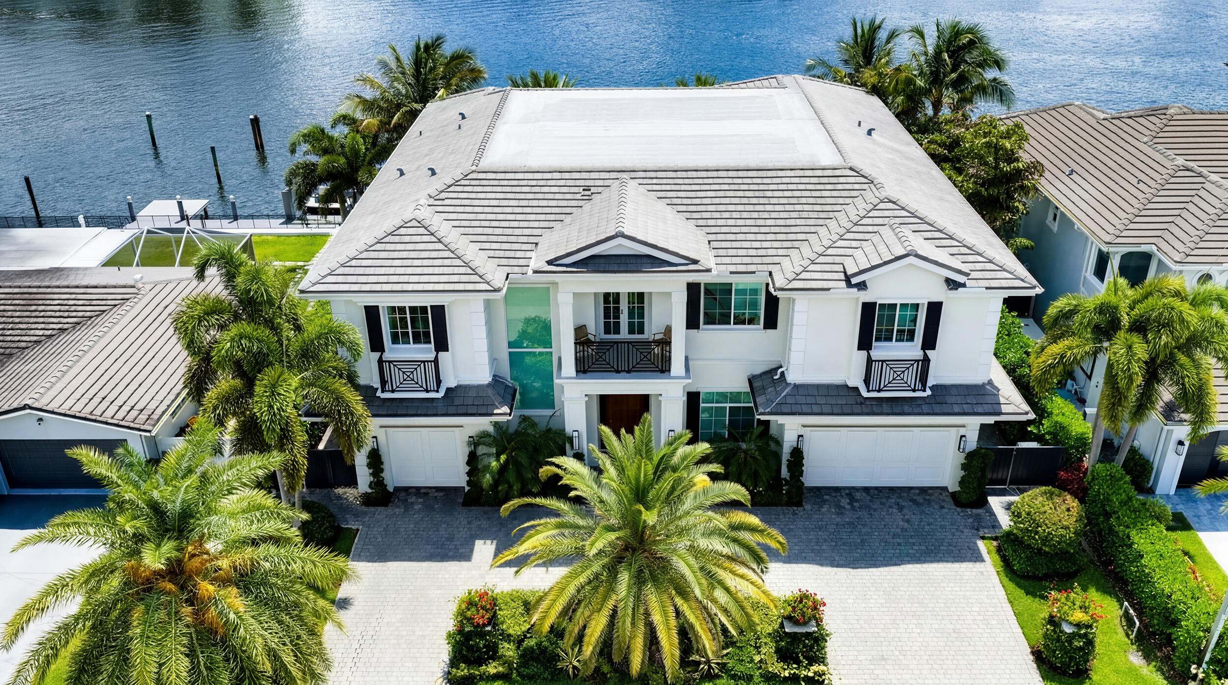 Beautiful landscaping sets the tone for this magnificent waterfront estate in Boca Harbour Island, imparting a luxuriant sense of place, while the rear gardens offer resort-style outdoor living. The loggia with a summer kitchen flows out to the ice-white marble patio and the sparkling 40-foot pool with a spa and waterfall feature, where afternoons slip into languid leisure. A boating-enthusiast's dream, this luxury residence fronts 85 feet on a wide stretch of the Intracoastal Waterway, and a 40-foot pier dock extends from the private 60-foot concrete dock, complete with a 15,000-pound hydraulic boat lift and a 5,000-pound Jet Ski lift. DISCLAIMER: Information published or otherwise provided by the listing company and its representatives including but not limited to prices, measurements, square footages, lot sizes, calculations, statistics, and videos are deemed reliable but are not guaranteed and are subject to errors, omissions or changes without notice. All such information should be independently verified by any prospective purchaser or seller. Parties should perform their own due diligence to verify such information prior to a sale or listing. Listing company expressly disclaims any warranty or representation regarding such information. Prices published are either list price, sold price, and/or last asking price. The listing company participates in the Multiple Listing Service and IDX. The properties published as listed and sold are not necessarily exclusive to listing company and may be listed or have sold with other members of the Multiple Listing Service. Transactions where listing company represented both buyers and sellers are calculated as two sales. "No payments made until title passes" Some affiliations may not be applicable to certain geographic areas. If your property is currently listed with another broker, please disregard any solicitation for services. Information published or otherwise provided by seller, listing company or its representatives is deemed reliable but are not guaranteed and subject to errors, omissions, or changes without notice. Copyright 2025 by the listing company. All Rights Reserved.