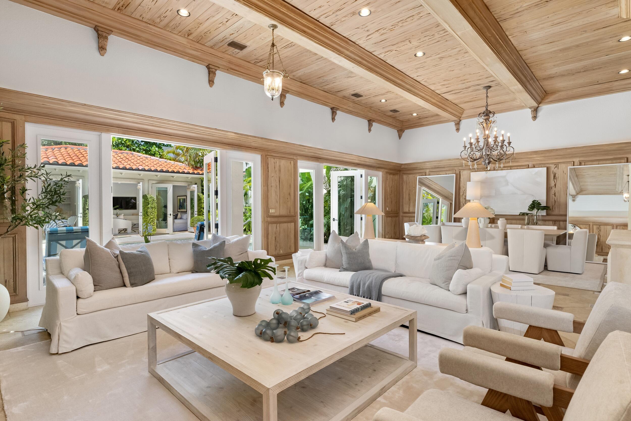 New roof just installed! Located on the beach block in the heart of Midtown Palm Beach, 175 Sunset Avenue has undergone extensive renovations and offers a rare opportunity to own a property with unusually high elevation for Palm Beach (11'2'') in one of the island's most sought-after locations. This stunning 4-bedroom, 5-bathroom townhome features a dramatic 34+ foot long living and dining room with soaring 14-foot coffered Pecky Cypress ceilings, creating an extraordinary sense of scale and grandeur unlike anything on the market currently. Newly renovated kitchen and bathrooms add a fresh, modern touch to the home. A separate guest house—an uncommon find in Midtown Palm Beach—includes a fully updated kitchen and bath, ideal for hosting guests with comfort and privacy. Additional highlights include a private library, an elevator, a secluded pool designed for peaceful outdoor living, a full-house generator, and impact windows and doors.

Just moments from the beach, the Lake Trail and The Royal Poinciana Plaza, this home offers the privacy of a single-family residence with the convenience of a townhome.
