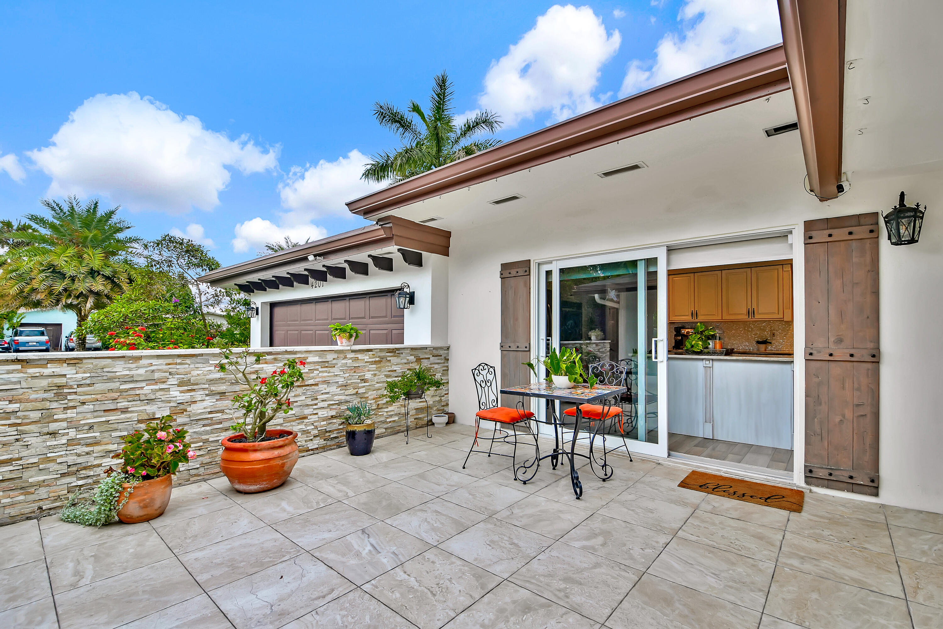 Welcome to this one-of-a-kind tropical retreat in the highly desirable Hollywood Hills. Situated on an oversized double lot on a quiet street, this beautifully remodeled residence offers the perfect blend of luxury, privacy, and resort-style living. The open-concept floor plan features Italian porcelain flooring throughout and a custom-designed kitchen with exotic quartzite countertops, stainless steel KitchenAid appliances, dual wall ovens, warming drawer, gas cooktop, abundant cabinetry, and a two pull-out pantries. The spacious layout includes three bedrooms in the main home plus a private in-law suite with its own private entrance and full bath, ideal for guests, extended family, a home office, or a second primary bedroom suite. The primary bathroom was fully remodeled this year 2026.  Step outside into an extraordinary backyard oasis unlike anything else in Hollywood Hills. This home was made for entertaining. A saltwater pool surrounded by Chicago brick pavers serves as the centerpiece of this lush tropical paradise. Featuring an elegant outdoor kitchen (2025) and cabana bathroom. The centerpiece is a magnificent 50 year-old banyan tree providing natural shade and a breathtaking setting for outdoor entertaining. Wander through professionally designed gardens featuring exotic trees, a tranquil tropical fish pond, dramatic black stone accents, and a spectacular three-tier Massarelli fountain. Nature lovers will appreciate the dedicated butterfly and hummingbird gardens, attracting hundreds of butterflies in the spring and hummingbirds throughout the season. Additional features include, natural gas generator (2025), new Trane A/C under warranty (2020), saltwater pool with new pump, updated electrical throughout the entire house, outdoor professional sound with WiFi, 2 storage sheds, irrigation system with three zones and over 50 independent heads. enchanting illumination at night from the landscape lighting. This exceptional property offers a rare opportunity to own a private sanctuary while being conveniently located just minutes from the beach, major highways, hospitals, places of worship, schools, and more. New Pictures coming soon