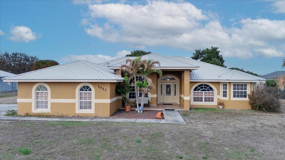 SELLER IS OFFERING $5,000 CREDIT TOWARDS BUYER'S CLOSING COSTS! Location, convenience, and comfort come together in this beautifully maintained home in a highly desirable area. This spacious residence features 3 bedrooms plus a den—perfect for a home office or easily used as a 4th bedroom—along with 2 full bathrooms and a 2-car garage, offering flexibility for today's lifestyle.  Enjoy peace of mind with major recent upgrades, including a newer A/C (2025), newer water heater (2025), and a durable metal roof. The gorgeous kitchen features granite countertops, beautiful wood cabinetry, and stainless steel appliances, creating an ideal space for both everyday living and entertaining.  The master bathroom provides a comfortable retreat with dual sinks, a separate shower, and a relaxing jacuzzi tub. Step outside to the screened porch, perfect for morning coffee or unwinding in the evening, overlooking a fenced backyard with a storage shed for additional storage.  Unbeatable location—within walking distance to Walmart, schools, shopping, and restaurants, making daily errands easy and convenient while helping you save time and gas.  A wonderful combination of location, upgrades, and lifestyle—don't miss this opportunity!