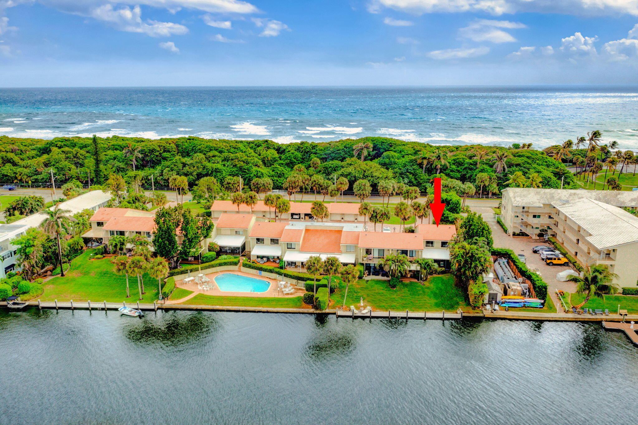 SPECTACULAR AND RARELY AVAILABLE WATERFRONT RESIDENCE nestled within the exclusive 12-unit boutique community of Ocean Cay. This exceptional corner, two-story condominium has been thoughtfully designed and fully renovated with impeccable craftsmanship and attention to detail throughout. Offering over 2,300 square feet of refined living space, this custom residence features 3 bedrooms, including a stunning first-floor primary suite, 3.5 beautifully appointed bathrooms, multiple private patios, impact windows, and a detached one-car garage. Privately tucked away in Ocean Ridge, this home showcases panoramic Intracoastal Waterway views and direct beach access just across the street. Impressive upon entry, the light-filled, multi-level floor plan seamlessly blends expansive living and dining areas, all framed by breathtaking water views from nearly every room. The gourmet kitchen is a true showpiece, featuring custom cabinetry, Quartz countertops, high-end GE Café appliances, a designer backsplash, and elegant gold finishes throughout. The generous first-floor primary suite offers wood flooring, designer wall coverings, an expanded walk-in closet with custom built-ins, and a private outdoor patio. The spa-inspired primary bath boasts custom cabinetry, an oversized dual-sink vanity, LED mirror, Quartz countertops, an elegant glass-tile accent wall, a freestanding soaking tub, and a frameless glass shower. A custom staircase leads to two private guest suites, each offering incredible water views and their own beautifully renovated en-suite bath. An adjoining  flex room provides ideal space for a yoga or Zen studio, home office, or playroom. Step outside and enjoy your private waterfront oasis. Relax with morning coffee or sunset cocktails from your covered patio overlooking the Intracoastal. This upscale Ocean Ridge residence also offers a tranquil community pool with water views, dock rental availability exclusively for owners, and effortless coastal living. With countless upgrades and thoughtful details throughout, this exceptional home must be seen to be fully appreciated. From the moment you arrive, it is clear this rarely available residence is truly special: defined by breathtaking views, refined finishes, and an unparalleled lifestyle. Enjoy spectacular sunsets, nearby fine dining and shopping, and the very best of waterfront living. A beautiful lifestyle awaits.
