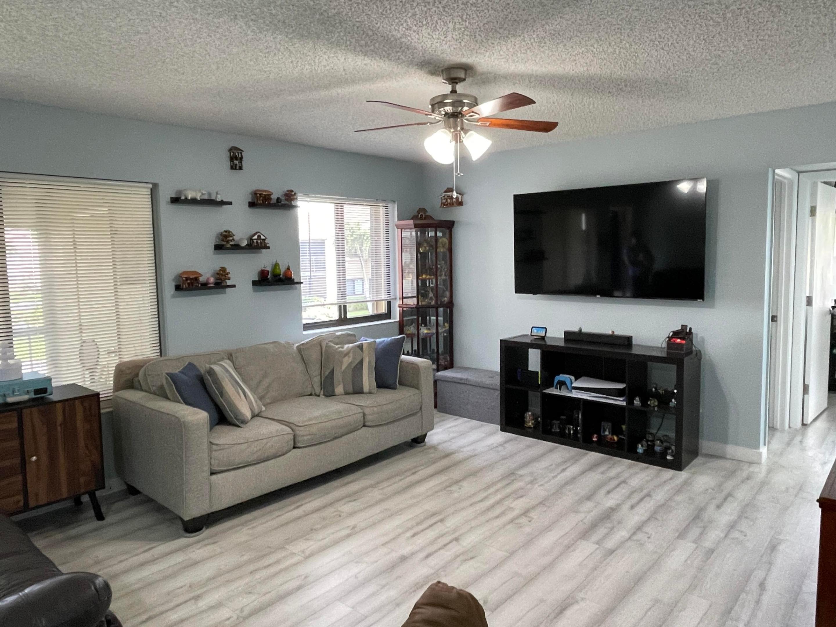 Great location, in excellent run community, manicured gardens, this 2 bed 2 bath is just steps from the community pool and clubhouse, it is on the second floor with a court/balcony entrance, it feels very cosy, nice wall accents, remodeled kitchen, nice tile and laminate wood floors throughout, nice large living room dining and kitchen area. Large master bedroom with built in closets, new hurricane windows, A/C is 2022, also accordion shutters, laundry room with full size washer and dryer. Brand new roof. Large attic space.