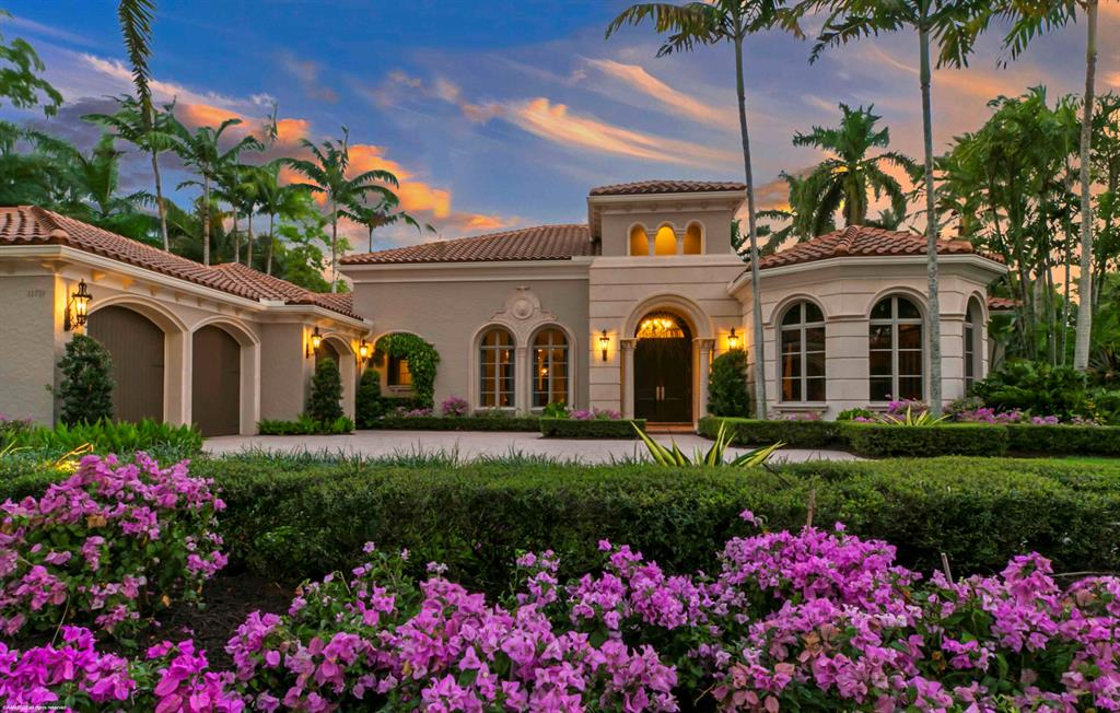 Elegantly stated Castillo floor plan on one of the most coveted streets within Old Palm Golf Club.  This private enclave faces a beautiful nature preserve, and boasts lush landscaping; a private, tropical water feature view; expansive covered lanai with Pecky Cypress ceilings, breezy awnings, new summer kitchen including ice maker, beverage center, BBQ grill, gas burner, and sink; bathe outdoors under the stars in the custom teak shower with bench and light; the custom heated pool & spa is a great place to relax and unwind.  Custom double front doors invite you into the home featuring marble floors, volume ceilings with lots of details throughout, crown moldings and rich appointments. Grab a cocktail with friends at the custom wet bar with gorgeous Onxy tops; host a dinner party in the formal dining room with butler pantry and wine storage. Gather with family and friends in the casual family room which is open to the kitchen and accessible to the pristinely manicured backyard.  When the party is over retreat to the Master Suite with lavish bathroom, his and her vanities, spacious shower, jetted tub, his & her water closets and ample closet space with custom built ins.  Spoil guests in the guest suites featuring private bathrooms and access to the palm tree lined courtyard. The full 3 car garage with custom built in storage will keep tools and cleaning items neatly tucked away.  
Other features: 48 kw generator, paver walkways on both sides of the house, new roof (2022), updated wallpaper throughout, new Onyx tops, new leather finish tops in the kitchen, custom hood over the cooktop, lots of upgrades!