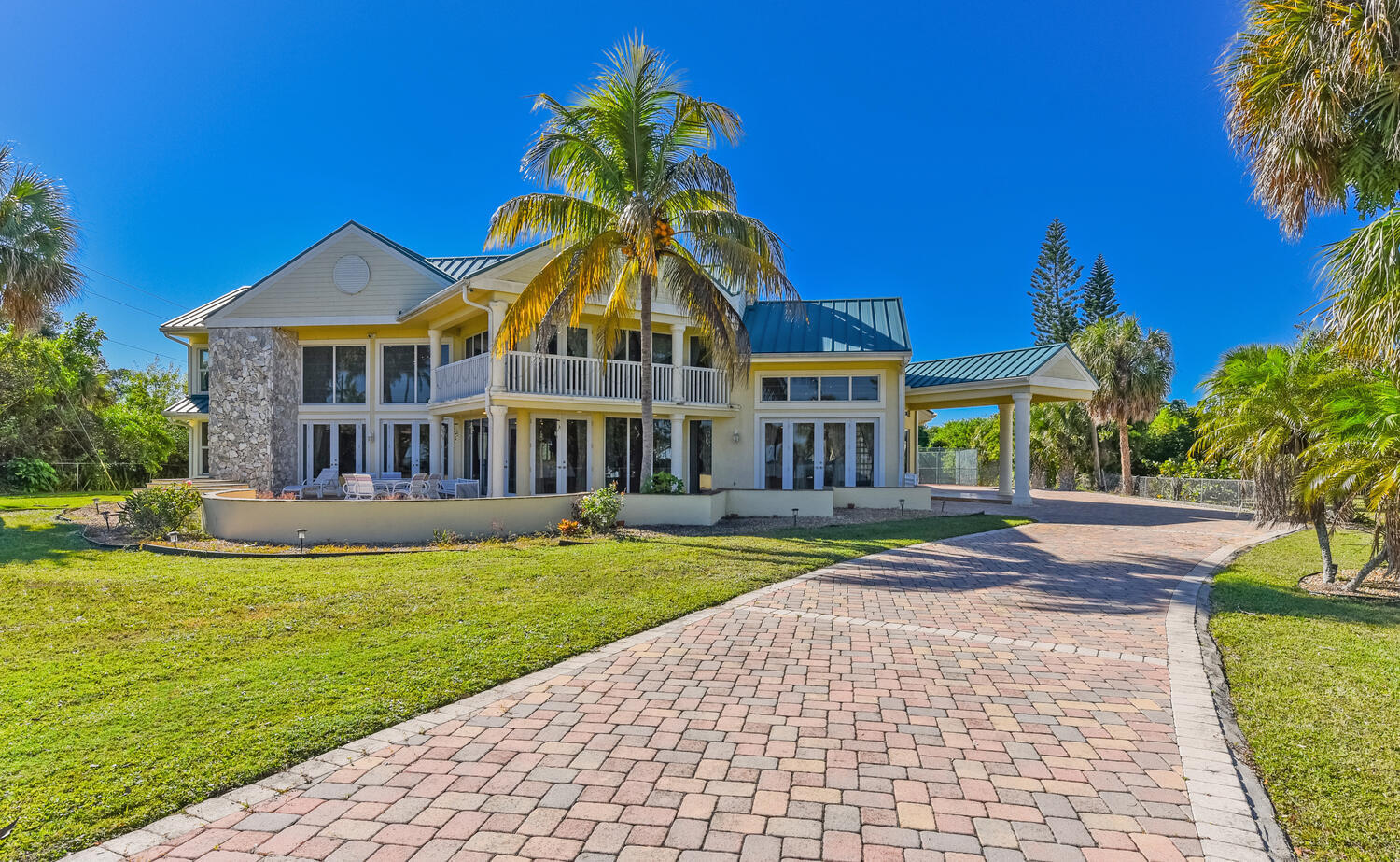 PRICE REDUCED , Treasure Coast Mansion, 3343 S Indian River Dr, this estate , is set back on a 3.5 acre lot of private riverfront land with 151 feet of waterfront. measuring 7,400 sq ft under A/C,  The views are amazing, you'll be just 8 minutes away from the deep-water marina's and 10 minutes from the ocean inlet. The estate offers five bedrooms with the option for eight, 5.5 bathrooms, a safe room, a game room, a media room, and a full-size sauna.  The main entrance features custom stained glass doors, a parlor room, a formal dining room with a two-sided fireplace, a family room with a high-soaring ceiling, an office, a breakfast nook, and a large chef's kitchen. The home was completely renovated in 2009, featuring impact-resistant windows and doors, a metal roof, new tile floors Updated electrical systems, new plumbing, and is Crestron-wired with Wi-Fi Devices. The 2nd-floor master bedroom features a fireplace, a wood cathedral ceiling, and a walk-out balcony.  The second floor features gorgeous wood floors, with four bedrooms and four bathrooms.  Shops, theaters, restaurants, hospitals, the international airport, and beaches are all just a few minutes away. The expansive property can accommodate a large garage/building for car enthusiasts, horses, etc. Far-Bar " As Is " Contracts only Please