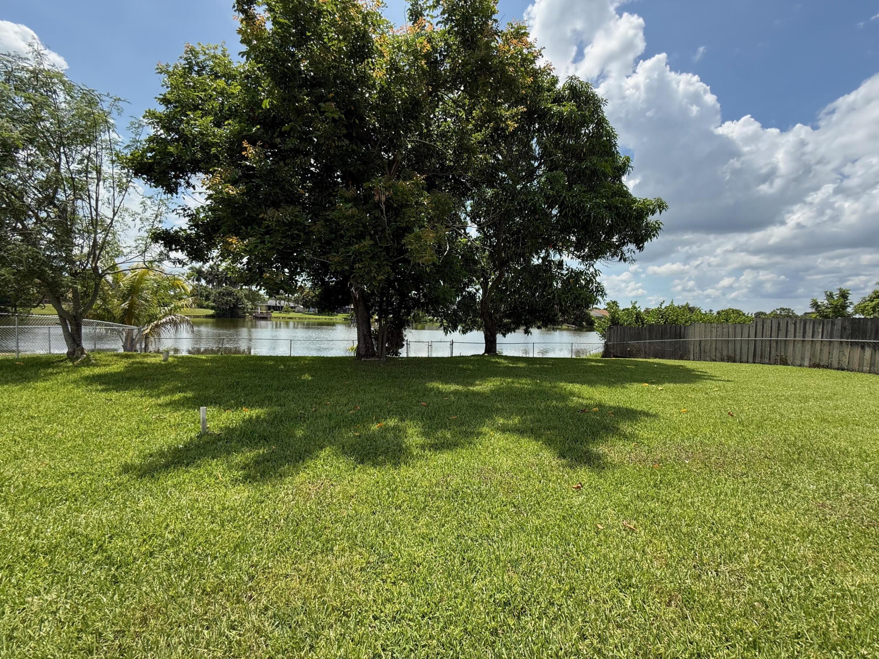 This exceptional property offers an unparalleled opportunity to create a custom waterfront paradise in a prime location that truly has it all. Step outside to embrace the beauty of the oversized lot, where mature fruit trees—including avocado, mango, and exotic Ackee—provide both natural shade & the delightful promise of homegrown harvests. The generous lot size affords ample space for your dream additions, such as a sparkling swimming pool or expansive entertainment areas. A massive screened-in patio serves as the perfect indoor-outdoor living extension. The interior offers a wonderful opportunity for personalization & updating, allowing you to create a truly custom home that reflects your unique style, crafting a modern masterpiece that harmonizes with the home's enviable setting.