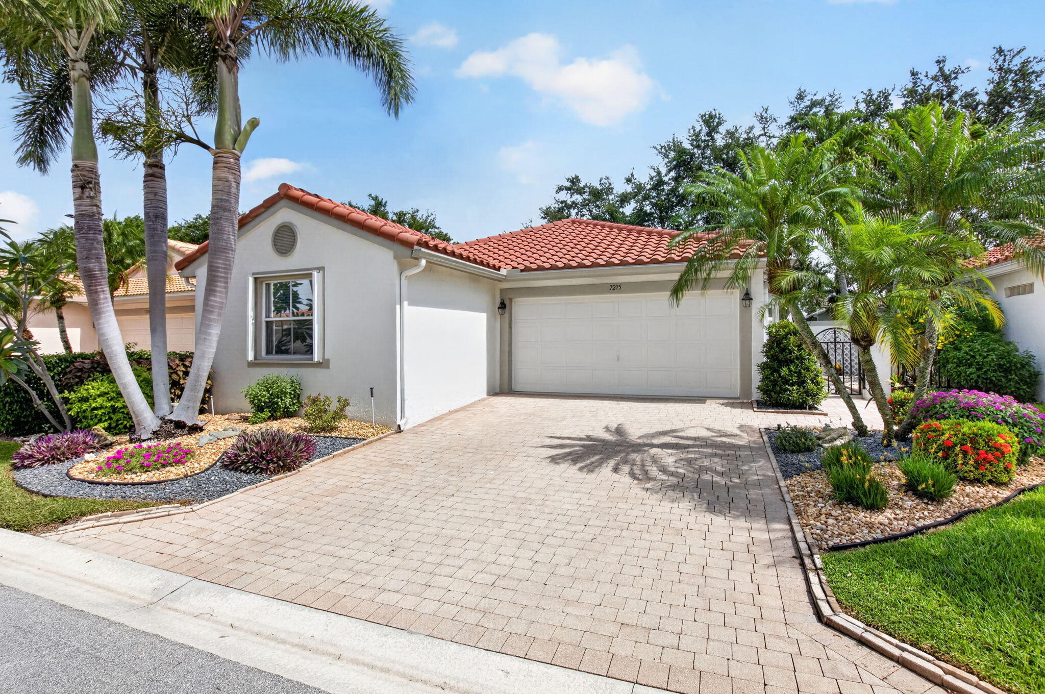 Welcome to 7275 Whitfield Avenue, a well-maintained 3-bedroom, 2-bathroom single-family home in the highly regarded Cascades community of Boynton Beach. Offering approximately 1,588 square feet of interior living space, this residence combines a functional layout with thoughtful updates and inviting outdoor areas.  A pavered walkway framed by lush landscaping leads to a private courtyard-style entrance, setting a refined tone from the outset. Inside, a bright, open floor plan connects the kitchen, dining, and living areas, creating an easy flow for everyday living and entertaining. Sliding doors open to a large wraparound, screen-enclosed lanai that extends the living space and provides a comfortable setting for outdoor dining and relaxation.  The remodeled kitchen is a central feature of the home, designed with new quartz countertops, a custom tile backsplash, flat-panel cabinetry, and stainless-steel appliances. Ample counter space and storage support both casual meals and larger gatherings.  Adjacent to the main living area, the primary bedroom offers a spacious retreat with a large walk-in closet and direct access to the home's core living spaces. The split floor plan places the additional bedroom and den on the opposite side of the home, along with a full bathroom, allowing for flexibility as guest accommodations, a home office, or hobby space.  The expansive screened patio enhances the property's livability, providing an additional area for entertaining or quiet enjoyment while overlooking the landscaped surroundings.  Residents of The Cascades enjoy an established, amenity-rich community setting in a convenient Boynton Beach location, with access to shopping, dining, and major roadways. The lifestyle and setting make this home a compelling opportunity for buyers seeking a move-in ready property in a well-situated neighborhood.  7275 Whitfield Avenue is offered for sale and available to view by appointment.