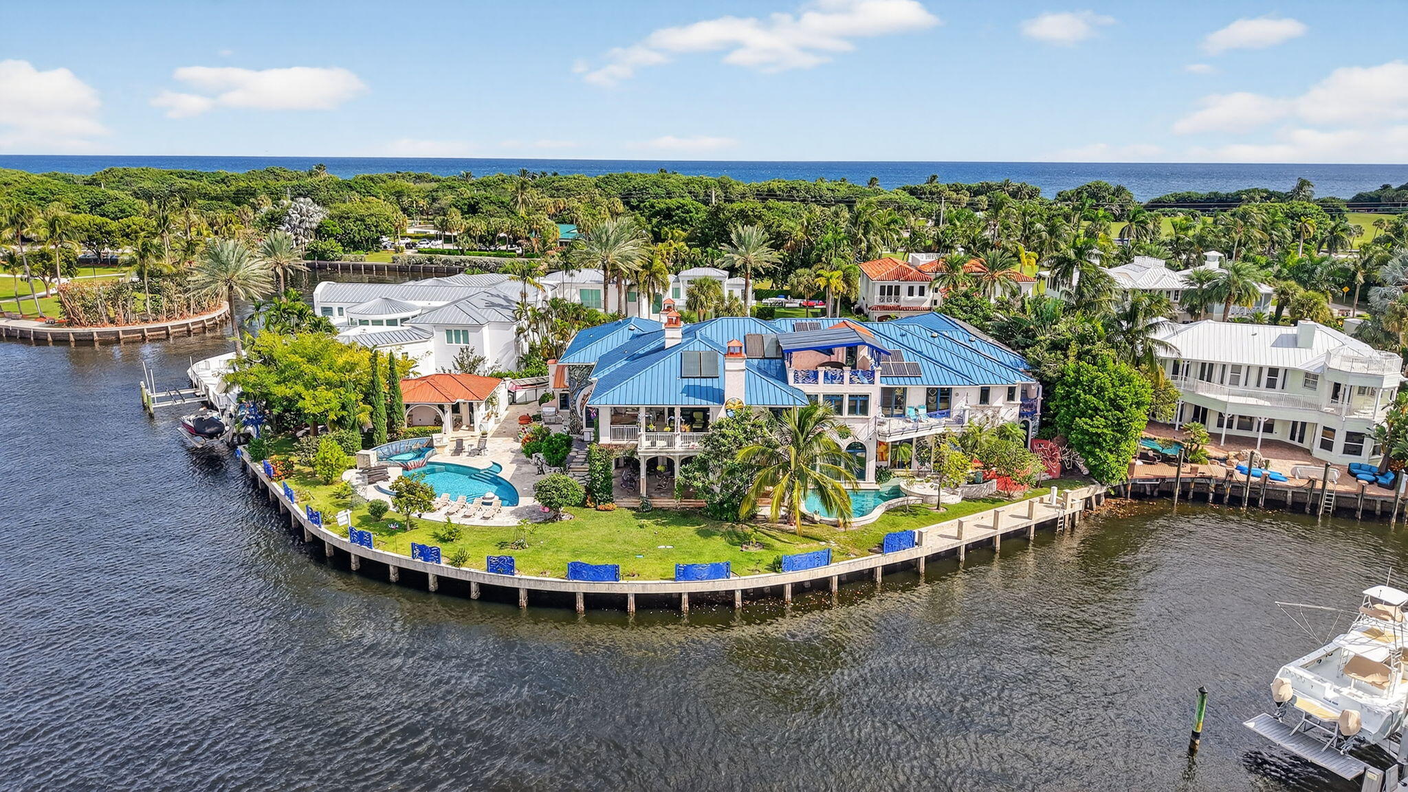 PRIME LOCATION! Exceptional DEEPWATER Intracoastal Estate nestled on a Barrier Island, quiet Cul-De-Sac street, surrounded by other trophy properties. Xtra Large, 256 FT., POINT LOT with breathtaking views of the intracoastal for the most discerning buyer. Timeless architecture and immersive design with artistic vision encompasses 12 bedrooms, 10+bathrooms, 6 fireplaces, 3 resort style private, heated pools, summer kitchen and bar, plus a detached guest suite, all surrounded by lush vegetation, adds to the charm and value of this home, capturing the energy, making it an absolute standout. Spectacular French inspired kitchen, walk-in refrigerator and freezer along with an exquisite dining area, allowing you to entertain at ease. *No charge Design Service is available with showing... A large European influenced master suite with sauna, jacuzzi, a crystal bed and radiant floors, includes spacious balconies with unparalleled, picturesque views. A truly unique and fun property. Deepwater frontage, unlimited dockage in a No Wake Zone, makes this is a BOATER'S DREAM! Only a short walk to play Golf and the Beaches...An INVESTMENT opportunity, this property offers an extraordinary world-class lifestyle! ........Land Value alone is worth it! Commercial grade, whole house electric generator with direct access to street natural gas, is a bonus..........so much upside and potential,,,,,,,,Motivated, SERIOUS OFFERS WELCOME !