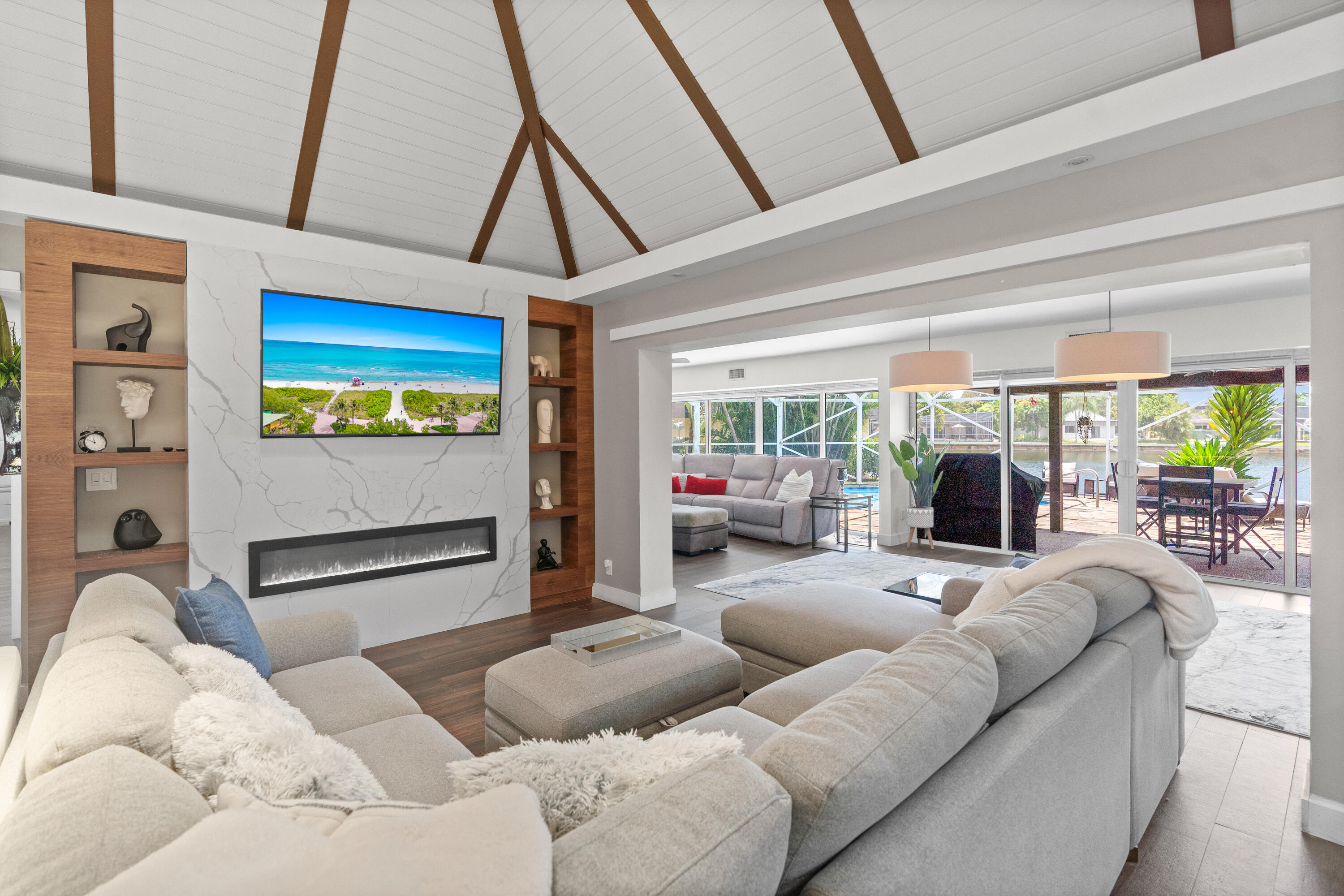 Completely remodeled and designed for luxury living, this stunning waterfront estate showcases the very best of The Woodlands. Offering 5 spacious bedrooms, 3 full bathrooms, soaring volume ceilings, and breathtaking lake views, every detail has been thoughtfully updated. Enjoy South Florida living from your private heated pool and screened patio. Complete impact windows and doors provide peace of mind, while paid off solar panels deliver exceptional energy efficiency. Located within the reimagined Woodlands community in Tamarac, residents enjoy over 160 acres of preserved green space and lakes, a 5-mile recreation trail, grand gated entrances, and a brand-new state-of-the-art clubhouse featuring a fitness center, café, resort-style pool and spa, padel and tennis courts, and more.