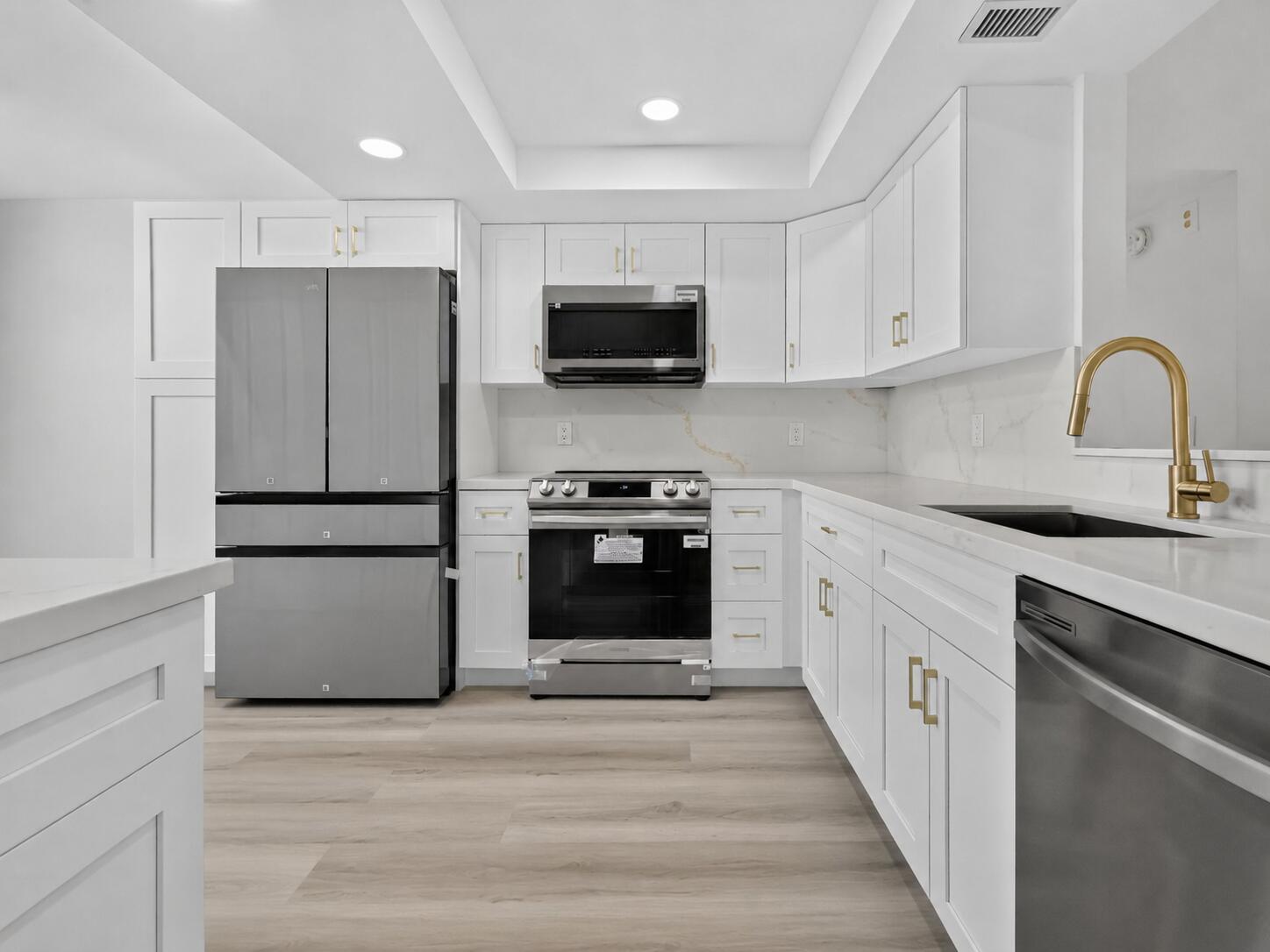 Welcome to easy South Florida living in this beautifully renovated first-floor condo in Abbey Village, an active 55+ community. This move-in-ready home offers 2 bedrooms, 2 full bathrooms, a fully renovated kitchen and bathrooms, brand new appliances, a 2024 A/C system, and impact windows throughout. The bright layout includes a Florida room and generous storage.  Conveniently located near shopping, dining, Downtown Delray Beach, and the Atlantic Ocean. An ideal full-time residence or seasonal South Florida retreat. *Listing is virtually staged*