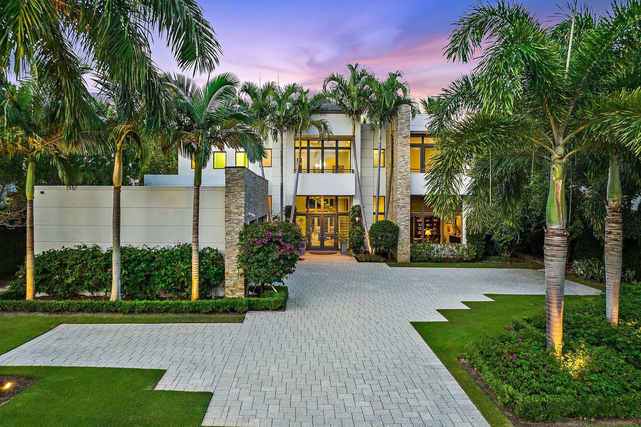 EXQUISITE Custom Waterfront Estate built in 2015 offers the finest quality construction. Built by award winning Couture homes this residence features poured concrete on both levels and premiere Anderson Impact Windows + Doors throughout. Sited on .78 Acres w/ 88' of Direct Intracoastal frontage in Harbor Place, a gated enclave of 7 custom homes. This home epitomizes elegance + comfort enhanced by modern functionality. Double height entry hall showcases a striking design palette accented by contemporary marble flooring and floor to ceiling windows. Impeccably maintained inside + out, this floor plan offers fluid design with grand scale rooms and water views from all main living areas. Design elements include marble fireplace, coffered ceilings, glass+marble staircase and private elevator. Formal living room is graced by a coffered ceiling, gas fireplace +custom millwork . The Chef's kitchen features Wolf + Sub Zero appliances with double ovens + dishwashers. Smart home upgrades include Control 4, Lutron lighting system and remote control A/C. There is a full home generator. Downstairs Primary Bedroom offers dual closets, morning bar, luxe bath and opens to a scenic lanai - private and serene. There is a second Owners Suite upstairs offering glamorous space and a zen spa bath. Bedrooms 3 to 5 are all grand in size with ensuite baths + dual closets. A grand Club room with lanai completes the upstairs. Thoughtfully designed to blend indoor + outdoor living, this home offers seamless transition from indoors to a manicured lawn overlooking the Intracoastal. Outdoor summer kitchen and pool with Spa and sun shelf are perfect for entertaining. Boating enthusiasts will love the direct Intracoastal location with easy access to the BOTH Jupiter + Palm Beach Inlets and turquoise Ocean! Dock w/ 16,000 lift, fits up to a 35' boat. Harbor Place residents enjoy a unique paradise w/ beautifully landscaped and maintained grounds and no homes across the street, only scenic greenery. Prime PBG location is minutes from best beaches, world class shopping, dining, educational and cultural venues. A truly fabulous place to live and enjoy!