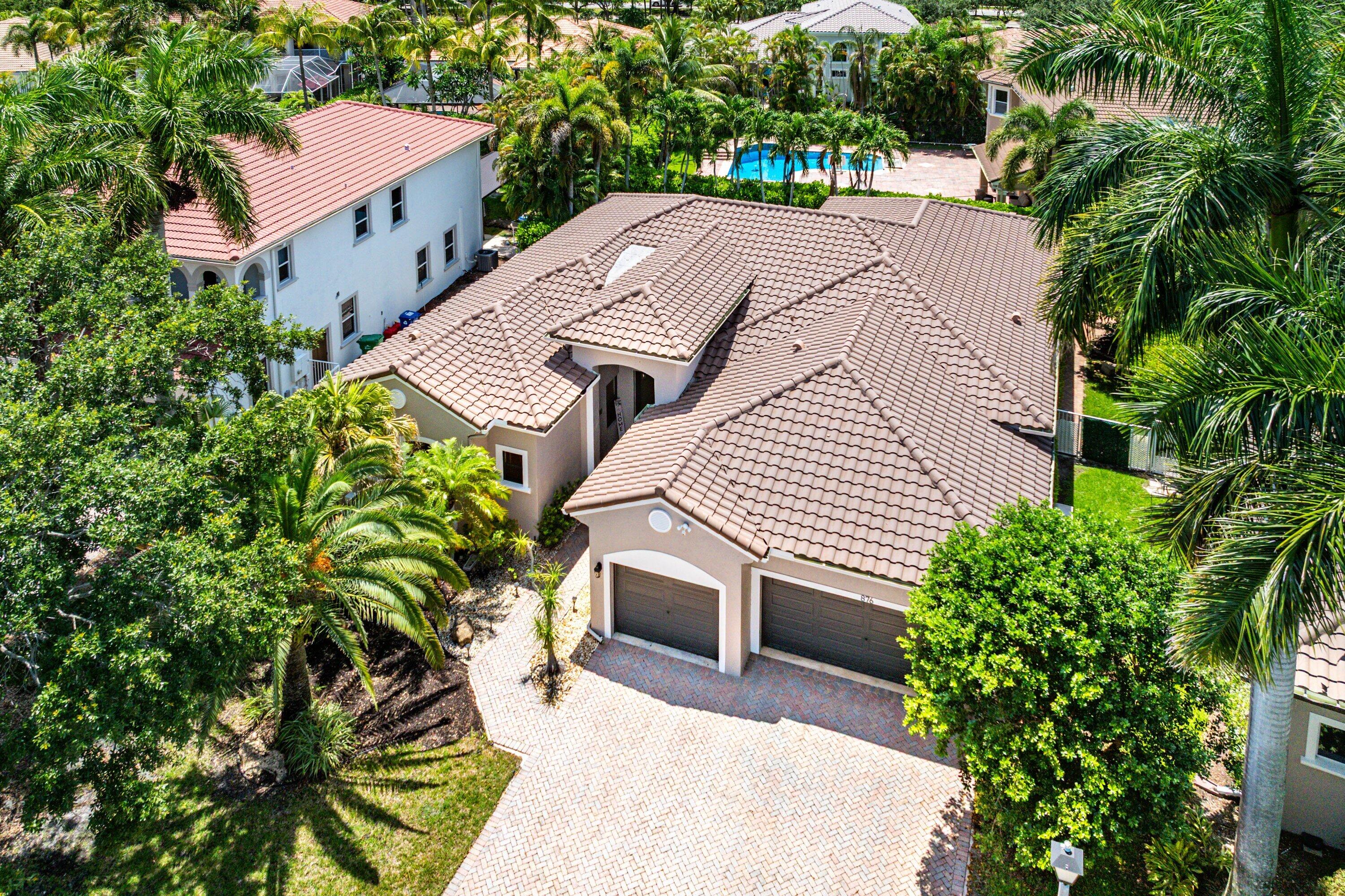 Venetian Isles Luxury Living Awaits! Nestled within a prestigious guard-gated community, this beautifully appointed residence with a 2019 Roof offers the perfect blend of elegance, comfort, and the South Florida lifestyle. Designed with a highly sought-after triple split-bedroom floor plan, the home features expansive living areas ideal for both everyday living and entertaining. The spacious family room and kitchen serve as the heart of the home, while the impressive primary suite provides a private retreat with a sitting area, generous closets, and a spa-inspired bath. Step outside to your own tropical oasis featuring a sparkling pool, relaxing spa, and expansive entertaining area. All impact windows and doors, along with an electric vehicle charger, add modern luxury and convenience.