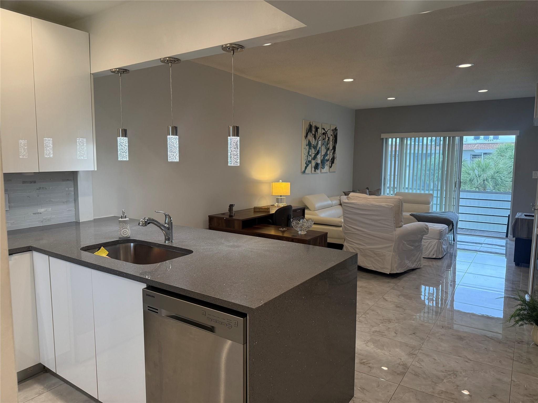 Beautifully updated 1-bedroom, 2-bathroom condo in the desirable Boca Teeca community. This top-floor unit features a modern kitchen with stainless steel appliances, granite countertops, and solid wood cabinetry, along with porcelain tile flooring throughout. Impact-resistant windows and doors provide added safety and energy efficiency. Additional upgrades include a 2018 AC, tankless water heater, and updated electrical panel. The spacious den offers flexibility and can serve as a second bedroom, office, or guest area. Enjoy abundant storage, including a custom-organized bedroom closet. Furniture is negotiable for a convenient turnkey option. Assigned parking, ample guest parking, beautifully maintained grounds, and a community pool complete this exceptional offering.