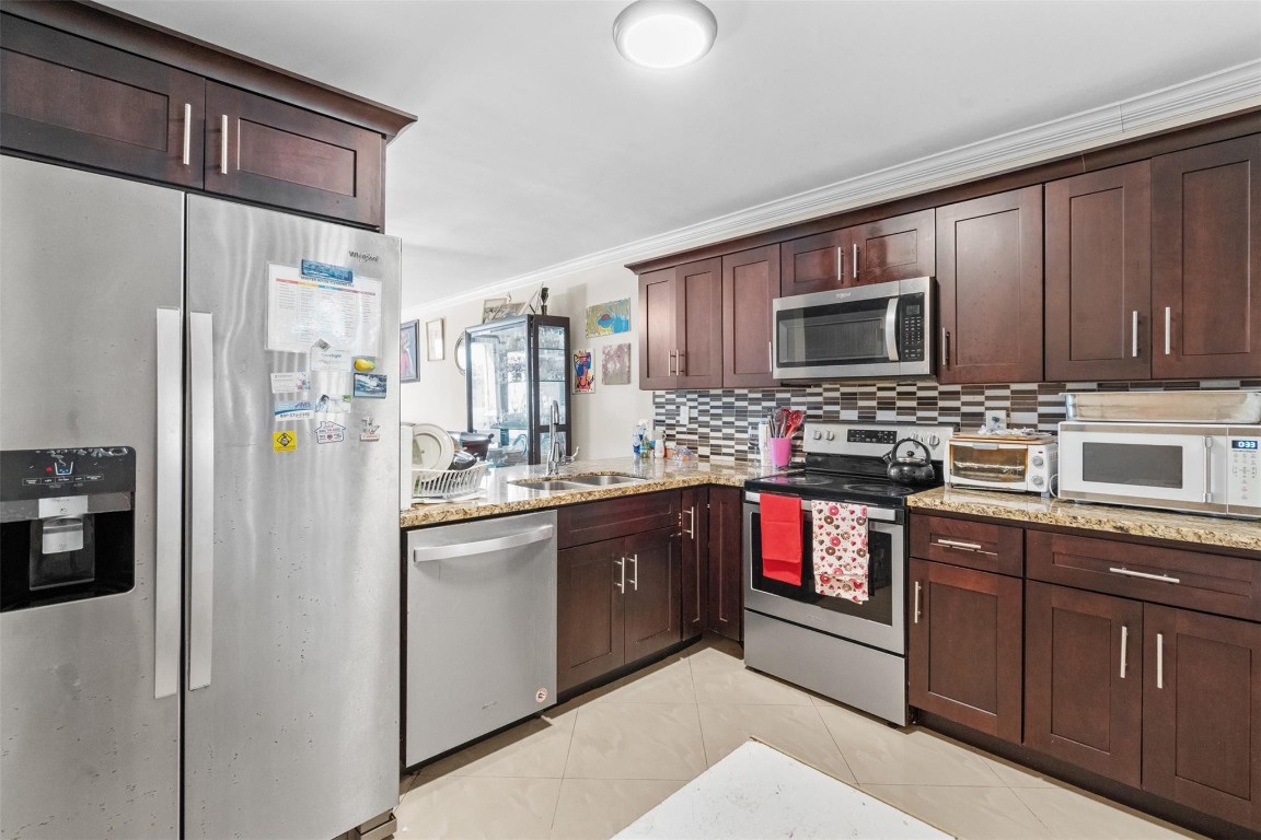 Beautifully updated 2 bedroom, 2 bathroom condo in the all-ages community of Courtyards of Broward. This spacious unit features a renovated kitchen with granite countertops, upgraded cabinets, tile flooring, and stainless steel appliances. Both bathrooms have been tastefully remodeled, offering a modern and clean feel throughout. Enjoy peace of mind with a new A/C system and a bright open living space. The community features a pool, clubhouse, secure entry, and is conveniently located near shopping, dining, and major highways. Move-in ready and perfect for year-round living or investment. 650 credit score required per association. HOA covers water, basic cable, garbage, sewage, pool, gym, clubhouse, building insurance, pest control. No rental restrictions. You can rent right away.