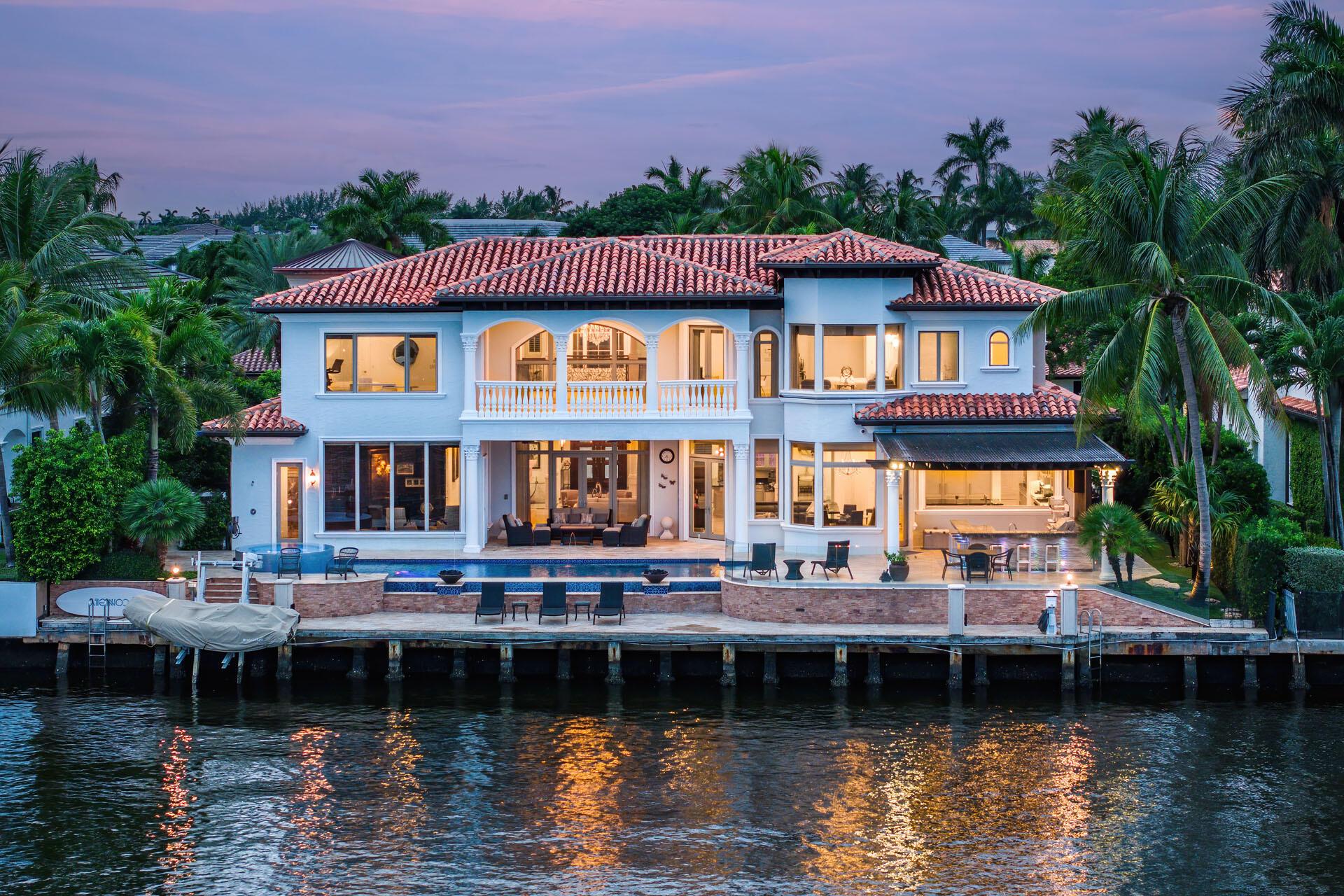 This exquisite estate offers a premier Intracoastal location defining luxury waterfront living in the prestigious Royal Palm Yacht & Country Club. With awe-inspiring vistas, marble floors, and lavish amenities, this extraordinary 5-bedroom haven is a testament to unsurpassed craftsmanship and refined aesthetics.

Unmatched features and elegance span over 8,000 sq ft on two floors. This estate offers a gourmet open-air kitchen, 7-seat home theater, distinguished study, cozy den with ensuite, and elevator access. The spacious master wing provides a sitting nook, exercise room, His & Her spa-like bathrooms, boutique-style closets, and mesmerizing waterway views from the covered balcony.

Step beyond the elegance indoors to discover a completely renovated resort-style pool with a raised spa and captivating fire bowls. It's an oasis that invites you to bask in luxury and serenity. You'll revel in abundant natural light all day with coveted east exposure. For water enthusiasts, a private dock awaits, providing swift access to the Intracoastal and the ocean inlet.