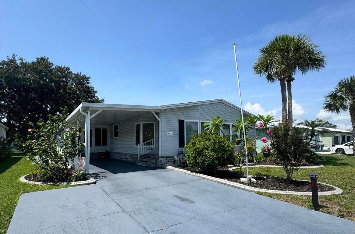 Lovely and Immaculate 2-bedroom 2-bath home in the desirable Spanish Lakes 55+community. Home has beautiful landscaping! The home has a large living room and a family room. Open kitchen with island. Home is perfect for those looking to entertain or just wanting extra space. Wet bar off kitchen. Beautiful lanai with windows that can open to a screened-in area or stay closed. Perfect for morning coffee or evening cocktails. The home has a shed off the back for extra storage. Home has a very private and peaceful backyard. Roof is 2014, A/C 2014, Water Heater 2022. Plumbing and vapor barrier have been replaced. Washer and Dryer 2023. Lawn care and trash removal included in lot rent. 2 pools, tennis, pickleball, bocceball, shuffle board. club house 18 hole golf course and much more. MUST SEE!
