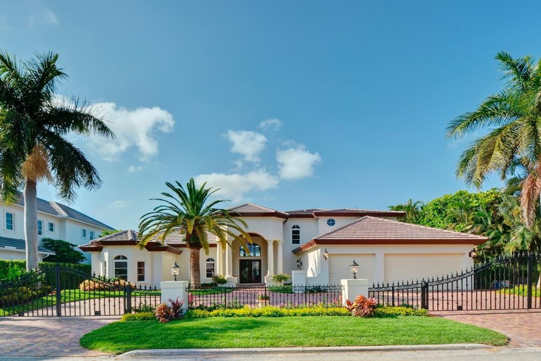 Updated waterfront home in Royal Palm Yacht & Country Club with 90ft on the water. Located on the Fishtail Palm Waterway, Royal Palm's widest canal, this property has a private dock with direct Intracoastal & Ocean access. Features include foyer entry, formal living room with fireplace, formal dining room, split bedroom floorplan, 1st floor master suite with a personal gym, volume ceilings, marble flooring, custom moldings and trim, custom built-ins, movie theater, gourmet kitchen with wood cabinetry, granite countertops and stainless steel appliances. Other features include heated pool & spa surrounded by marble pavers and all new landscaping, front circular driveway and 3 car garage. Updates include new roof, new A/C units, new stucco, new trim and all new impact glass windows and doors.