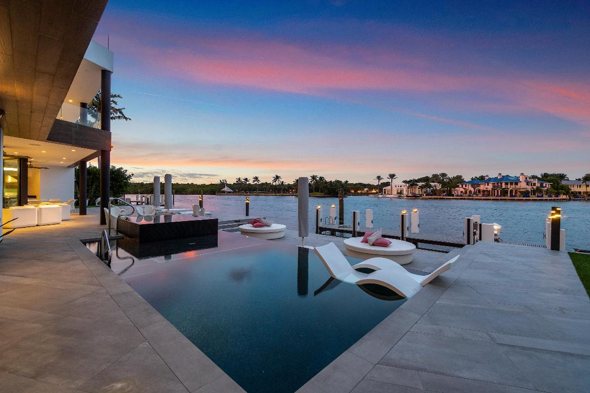 Ultra Contemporary Direct Intracoastal residence with 140 feet of waterfront and multiple deep water  boat mooring areas offers and some of the most expansive ICW water vistas in Boca Raton.  Designed as a total entertainment home with both covered and open outdoor patio, pool and spa. The first floor features a great room, dining, kitchen and dinette areas; full club room with bar, VIP guest suite and live-in staff quarters.  A second story Master Bedroom suite with office and covered patio terrace have sensational easterly and southern views down the non-wake waterway. There are four additional bedroom suites and a laundry area.  The third floor features an indoor bar area and two spacious rooftop entertainment areas, complete with a heated spa, all with waterway views.  More... EXTERIOR amenities
Located on a Cul-de-sac 
Slate pavers driveway
Contemporary 3 car garage 
3 story home 
Expansive and panoramic waterway views 
10 ft impact sliding glass door 
Water filter and softener 
Carrier AC 6 units 3, on the other side 
NAVIEN hot water heater 
Generac generator 
Pneumatic vacuum elevator
Widest intracoastal lot.  
Across from the red reef park 
Security cameras 
Garage  3.5 
Lutron lighting system
Fenced dog area

Entry :
Porcelain floor entry 
11 ft entry door. Metal 
Porcelain wall application & detail 
Porcelain tile floors 2.5 x 6 ft 
Walking thru the Front door you have direct intracoastal views 

Formal Dining area :
off the foyer 
With floor to ceiling windows. 
Room to easily seat 12 

Great room :
floor to glass ceilings 
Designed for a media wall for entertainment that can be seen from open kitchen and breakfast area 
Built in Fireplace 
Open lay out into the Kitchen and dining room.

Kitchen :
Lacquer cabinets, refrigerator, freezer. Subzero 
Beautiful blue glass counter island 
Quartz counter tops 
Wolf appliance gas stove & refrigerator
2 dual ovens, warming drawers, steamers, microwave, dishwasher (Miele)
Breakfast area with exceptional lighting. 
Automated solar shades. 

Club Room :
Bar area  club room family room seats 6 
Large space for entertaining

Media room:
Full media room
 sound walls seats 7 
projection unit 

Downstairs bedroom VIP suite :
Bedroom faces waterways
Has en-suite bathroom
Steeping tub
Walk in shower 
Double vanities 
walking closet
Rolling glass walls, glass shower enclosure 

Master suite:
Concrete pour w/ floor to ceiling glass windows 
Opens to a covered patio area and views of intracoastal waterway. 
Office from master and open bathroom 
With tub, double vanity. dual shower, full walk in closet 
separate water closet 
porcelain custom detail 
sliding glass doors for sound and privacy 


Covered patio :
Al fresco  outdoor summer kitchen 
Artificial grass.
Fire pit  outdoor flat screen media tv area. Adjacent to a covered patio dinette area. 
Seats 8 outdoor fireplace
Cabana bath.  Outdoor shower.

Pool :
Pool 33 x 16
Infinity edge spa
Pro series heat pump  heated pool 
Pool and spa heater 
Niven instant hot water systems 


Dock :
Ability to moor 120ft
Minimum wake zone 
Aluminum structure for wave runners. fits 2 
Rubber float for water 
Hydro power system for water and electric 
Underwater fish light 
Weather tech desk. Allows the boats being serviced on base and being moor. 


ROOFTOP
All porcelain floors and upstairs bar and interior sitting area 
Rooftop 3rd floor has entertaining bar area with indoor seating.  rooftop spa and artificial grass and 2nd BBQ with outdoor media are. 
With room for a large table seating 10, chaise loungers and umbrellas and chairs 
Outdoor shower - natural gas heater for spa
Spa dimensions 18 x 10
Glass railings 
35 x 18 entertainment area indoor sitting area 
38 x 15 south side 
48 x 28 north 
Security camera inside outside
20 x 9 spa upstairs