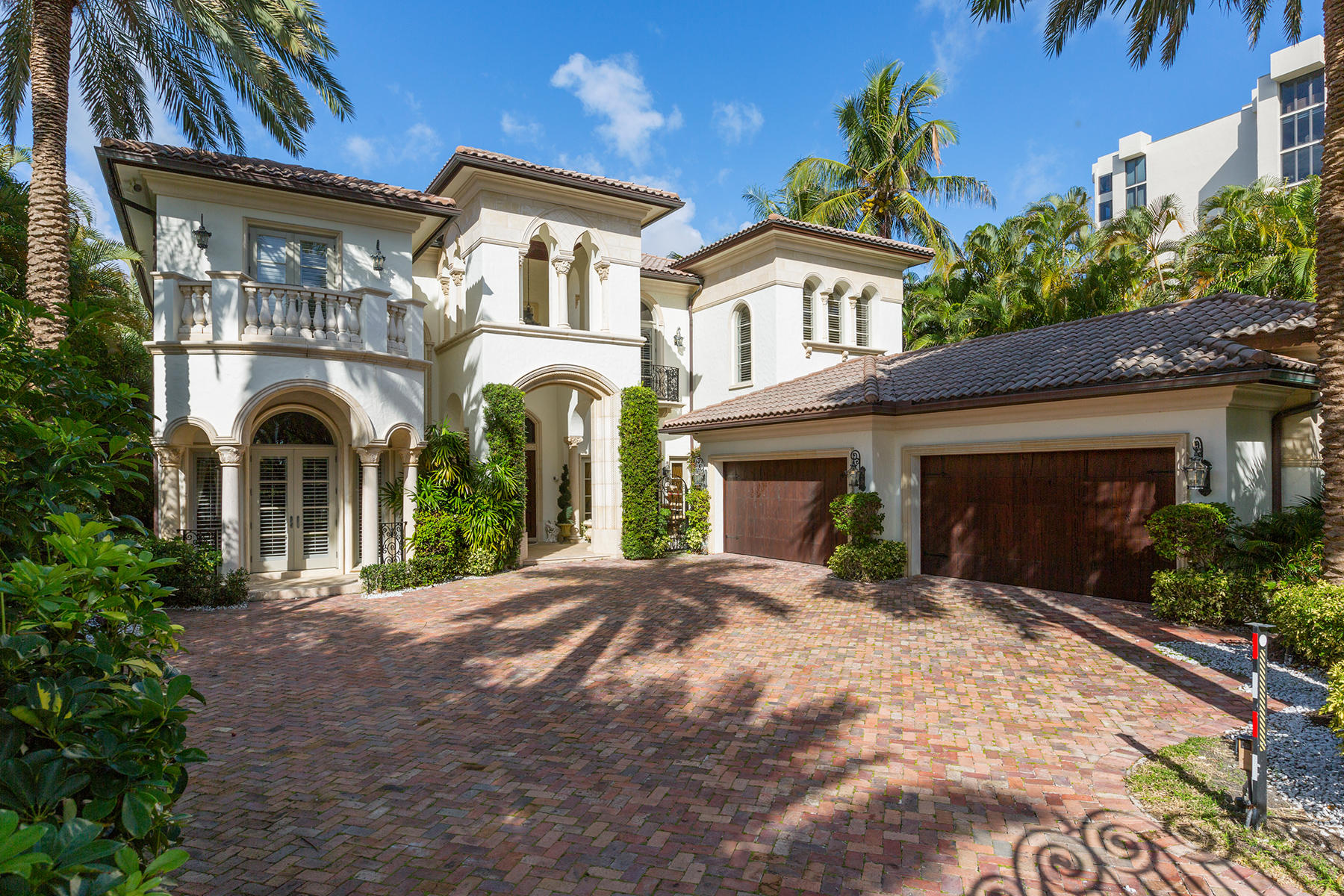 Italy comes to South Florida in this 10,000+ total sq ft timeless masterpiece by JH Norman Builders.   Located in the exclusive enclave of Highland Beach, nestled between Boca Raton & Delray Beach, this DIRECT Intracoastal gated home is a boater's paradise, beach goers dream and offers plenty of cheers to the wine lover with a temperature controlled room for 500+ bottles!  Custom boat lift in a private yacht basin fits a sizable boat up to 40,000 lbs.  90 ft directly on the Intracoastal with private deeded beach access and a beautiful pool and spa offer many opportunities to enjoy the best of all Florida water sports. Highlights of this property include an expansive open layout with soaring ceiling heights flanked by oversized impact windows offering the best of Intracoastal views. Perfect home for entertaining, toast the sunset in your summer kitchen and enjoy the sprawling patio & loggias that wrap around the back of the home offering plenty of space for sun worshipping, eating & dancing in the moonlight. Five en-suite bedrooms, his/her baths in the Master Bedroom featuring a steam room and spa & a balcony offering breathtaking views of the Intracoastal, pool & spa, 4 bay garage, 'Starry sky' movie theatre, elevator, paneled library with fireplace and laundry upstairs and down.  The gourmet kitchen enjoys state of the art appliances, Wolf 6 burner stove with grill plus a small & large oven, Thermador wall convection oven, oversized Sub-Zero refrigerator/freezer.  Glamourous onyx bar off of living room has hammered gold sink with Sherle Wagner fixtures & an ice machine. This home affords ultimate privacy from the moment you enter the gated and walled motor court.   Upon entry through the custom 9' Florida native Pecky Cypress doors you will understand why this home is the 'crown jewel' of Camelot on the Atlantic where the ultimate Florida lifestyle meets old world elegance!