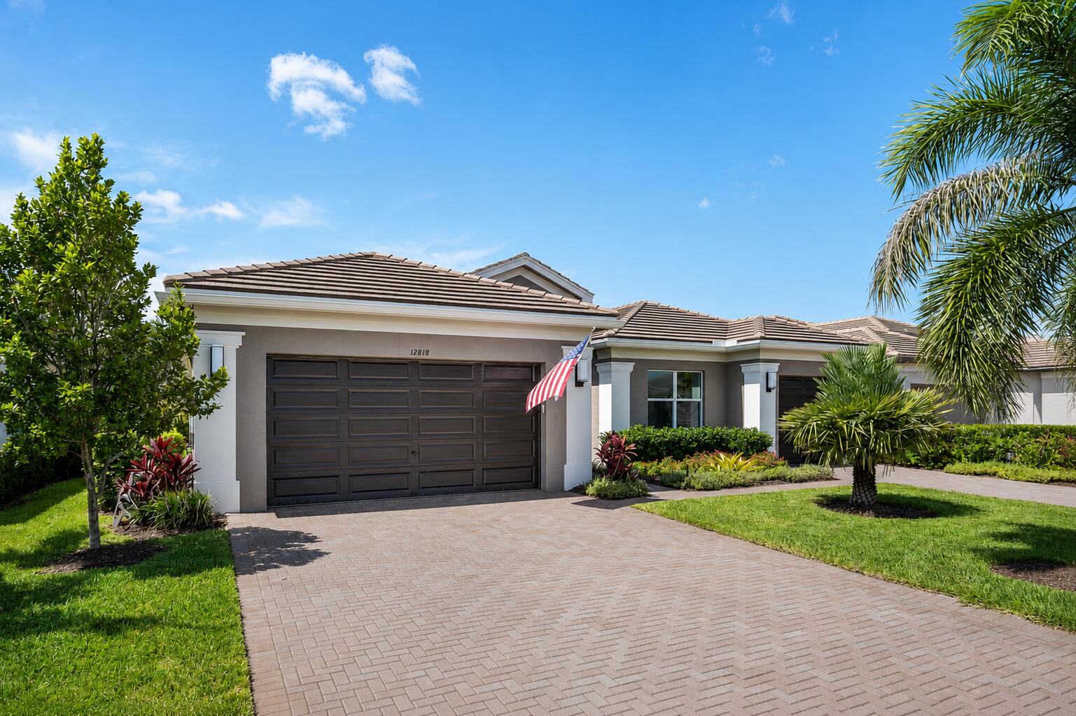 FOR  SALE - In GL Homes' highly sought-after 55+ Valencia Grove at Riverland, in Port Saint Lucie, FL. Designer elegance meets resort-style living in this extraordinary Bellagio model, part of GLs prestigious Crown Collection. This thoughtfully curated residence offers 2,645 square feet under air with 3 bedrooms, a den/optional 4th bedroom, and 3 full baths, including a private en suite guest bedroom, perfect for family and guests. From the moment you enter, you'll appreciate the extensive designer finishes, including wood-look tile flooring throughout (no carpet), crown molding, custom picture-frame molding in the foyer, luxury designer wallpaper, custom antique doors in the den, upgraded designer lighting, additional recessed lighting, and ceiling fans throughout the home. The gourmet    kitchen is as beautiful as it is functional, making it ideal for both everyday living and entertaining. It features ceiling-height cabinetry with custom drawer organizers and pantry pull-outs, an oversized island with abundant storage, and an artisan ceramic tile backsplash. A suite of GE Café appliances (with GE warranty through 2029) complements the farmhouse sink, custom pot filler, and premium Waterstone Wheel chef's faucet with matching soap dispenser.  The luxurious primary suite offers custom closet systems and a spa-inspired bath with porcelain tile, a custom-painted vanity, additional storage, a frameless zero-entry shower, and an opaque privacy window. Two beautifully upgraded guest baths feature custom vanities with frameless glass shower and tub enclosures. Designed for effortless Florida living, the outdoor oasis is every bit as impressive as the interior. The south-facing screened lanai provides cooler afternoons and comfortable evenings while overlooking the spectacular 13' x 30' Fountain Blue saltwater pool with a bubble shelf and raised tile wall with a waterfall. Entertain with ease in the fully equipped summer kitchen featuring a built-in gas grill, refrigerator, sink, and storage. Additional outdoor enhancements include a retractable screen, extended paver patio, backyard fencing, recessed lighting, and a large ceiling fan. Additional features include a Carrier Performance Series HVAC system, a 75-gallon water heater, Aquaman whole-house water filtration, whole-house gutters, a living room floor outlet, polyaspartic garage floor, overhead garage storage, and a widened driveway and front walkway. Indoor and outdoor furniture is negotiable separately.  Valencia Grove at Riverland offers one of Florida's premier 55+ resort lifestyles. Residents enjoy a spectacular 34,000-square-foot clubhouse with a resort-style pool, restaurant and bar, social hall, card rooms, billiards, and countless clubs and activities. The impressive 51,000-square-foot Wellness & Fitness Center features state-of-the-art fitness facilities, indoor sports courts, and a full-service spa. Outdoor enthusiasts will love the 16-acre Sports & Racquet Club with dozens of pickleball courts, tennis, bocce, miles of scenic walking and biking trails, an Arts & Culture Center, and a year-round calendar of entertainment and social events.  Ideally located near Tradition Town Center and the new Riverland Publix shopping center, residents enjoy an ever-growing selection of fine and casual dining, shopping, and everyday conveniences, with even more restaurants and retail coming soon. Cleveland Clinic Tradition Hospital, Mets spring training at Clover Park, PGA Village, I-95, Florida's Turnpike, and the Treasure Coast's beautiful beaches are all just minutes away. Every detail has been carefully selected, creating a home that is as functional as it is beautiful, a true showcase of luxury Florida living.