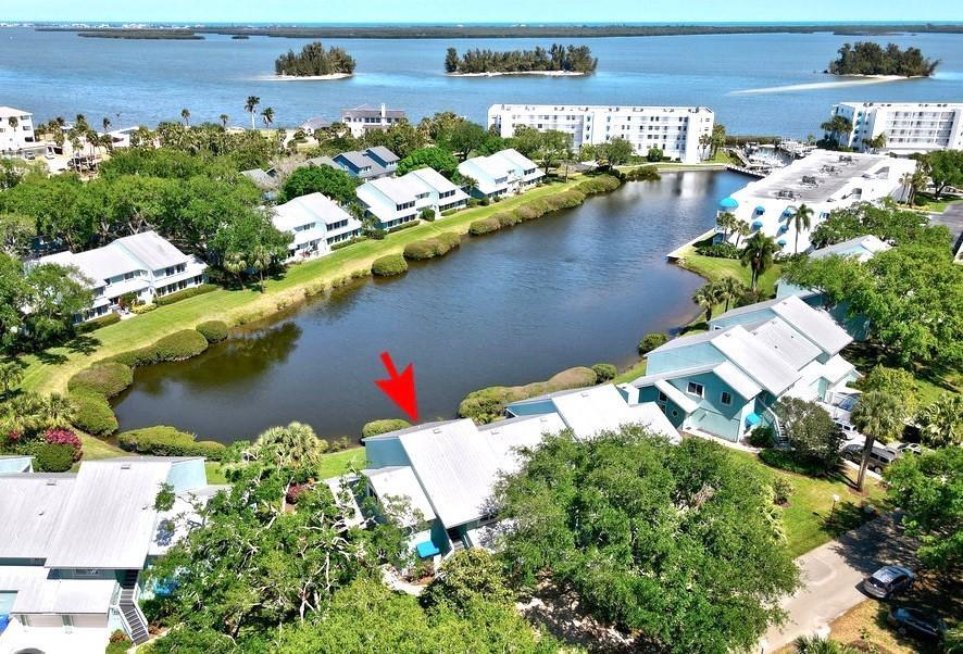 Welcome home to your beach-inspired, fully-furnished dream condo! Just bring your toothbrush and your zest for Florida living. Enjoy the 17' sunroom featuring expansive 2nd floor lake views, just steps from the intracoastal waterway. The ss kitchen & bathrooms are tastefully updated to make you feel right at home. Solid impact windows for peace of mind. New washer/dryer stack. AC 2023 w UV. Private 1-car garage. River Run: Marina, pool, tennis/pickleball & clubhouse. Boat slips with lifts are also available for purchase or rent. Small 35lb pet allowed. Wow, this is a must-see. Act fast!