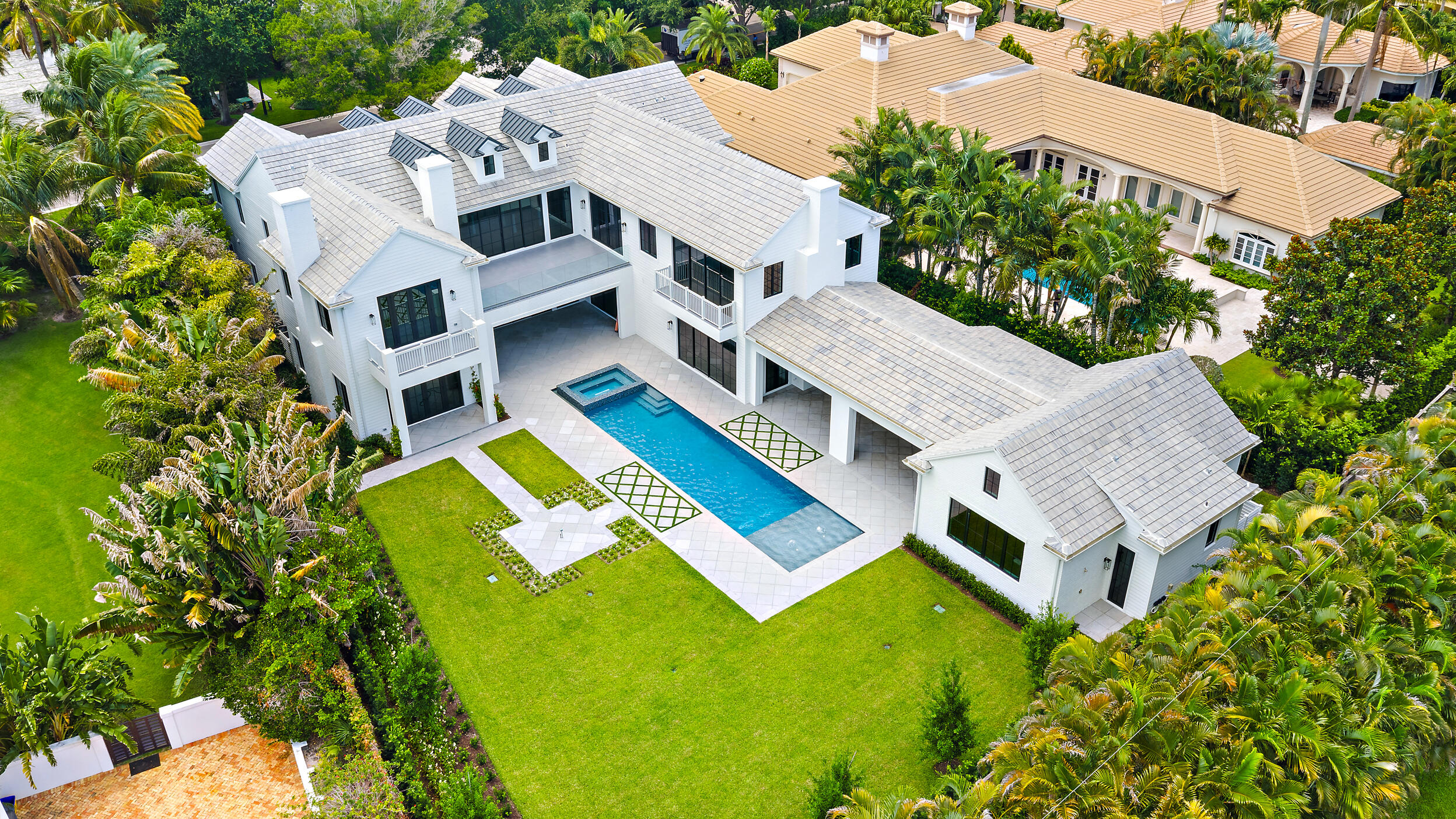 Brand new construction situated on an oversized 0.61-acre lot, 467 Mariner Drive offers a rare combination of scale, quality, and outdoor space within Admirals Cove. Thoughtfully designed with high-end finishes throughout, the home showcases beautiful craftsmanship, quality construction, and expansive living spaces tailored for both everyday comfort and entertaining.  One of the property's most unique features is the detached pool house, providing incredible flexibility to fit a variety of lifestyles. Whether envisioned as a guest house, game room, theater, fitness studio, private office, party barn, or the ultimate man cave, the space offers endless possibilities and creates a level of versatility rarely found within the community.  The oversized homesite is equally impressive.  At 0.61 acres, the property offers an expansive backyard setting that is exceptionally difficult to find in Admirals Cove. The generous outdoor space creates a true private retreat, complete with a resort-style pool and spa, putting green, bocce court, and multiple areas designed for gathering, entertaining, and enjoying South Florida's year-round outdoor lifestyle.  With large-scale entertaining spaces, luxury finishes, a detached pool house, and one of the most spacious backyard environments in Admirals Cove, 467 Mariner Drive represents a unique opportunity to own a newly constructed home on one of the community's most desirable homesites.