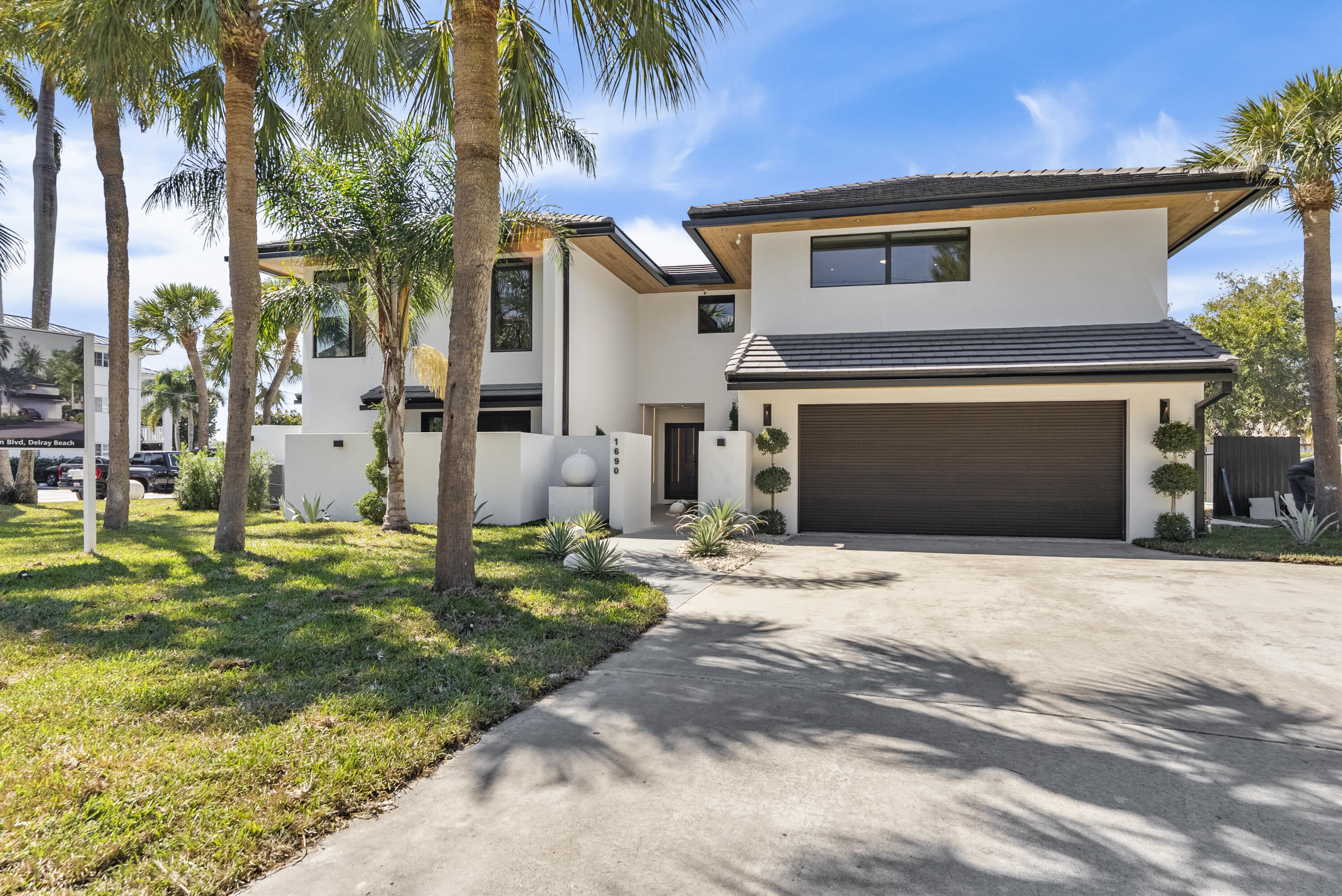 Coastal luxury meets modern perfection in these stunning attached homes just moments from the beach in one of Delray Beach's most sought-after locations. Perfect as a luxury residence, vacation retreat, or exceptional income-producing investment with strong short-term rental potential. Situated steps from the ocean and minutes from Atlantic Avenue's dining, shopping, and entertainment, the location makes these homes highly desirable for seasonal and vacation renters. Fully renovated from top to bottom, every detail has been thoughtfully designed to impress,from gorgeous wood flooring and sleek custom cabinetry to bold hinge-less solid wood doors creating a clean, modern aesthetic.  The chef-inspired kitchen features premium Thermador appliances, seamlessly blending style and functionality, while rich wood-paneled accent walls add warmth and upscale coastal elegance. Additional upgrades include a brand-new AC system, custom designer lighting, elegant wallpaper accents, and spa-inspired bathrooms with exquisite luxury tile work. Whether you're seeking a sophisticated beachside lifestyle, a second home, or an exceptional investment opportunity with excellent rental income potential of $60,000 a month plus during season, these beachside homes deliver the best of both worlds.