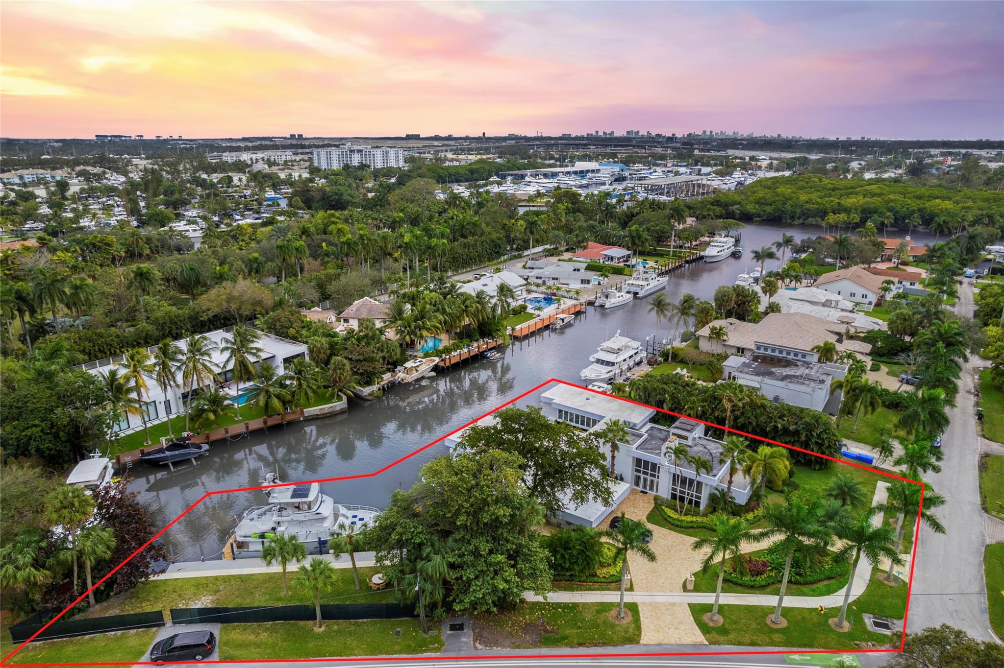Boasting over 200' of combined deep water frontage double lot estate this game-changing luxe over-water retreat with crazy great multi-slip deep-water dockage. Main home and adjacent property comprise this estate. Water-frontage maximized to the fullest w/out blocking the view. 90’ yacht dockage w/hip-tie TENDER + 5 other docks. A distinctive, Frank Lloyd styled masterpiece. Step in the door and you are on board. Only two such properties ever built in FTL. The artisan-owners have improved and impeccably maintained every inch. Expected, well-appointed luxurious accoutrements abound. The multi-dimensional pool, cabana, and light-infused expanses propel this estate and dockage heaven to game-changing status. If ever there was a must-see, this is it.