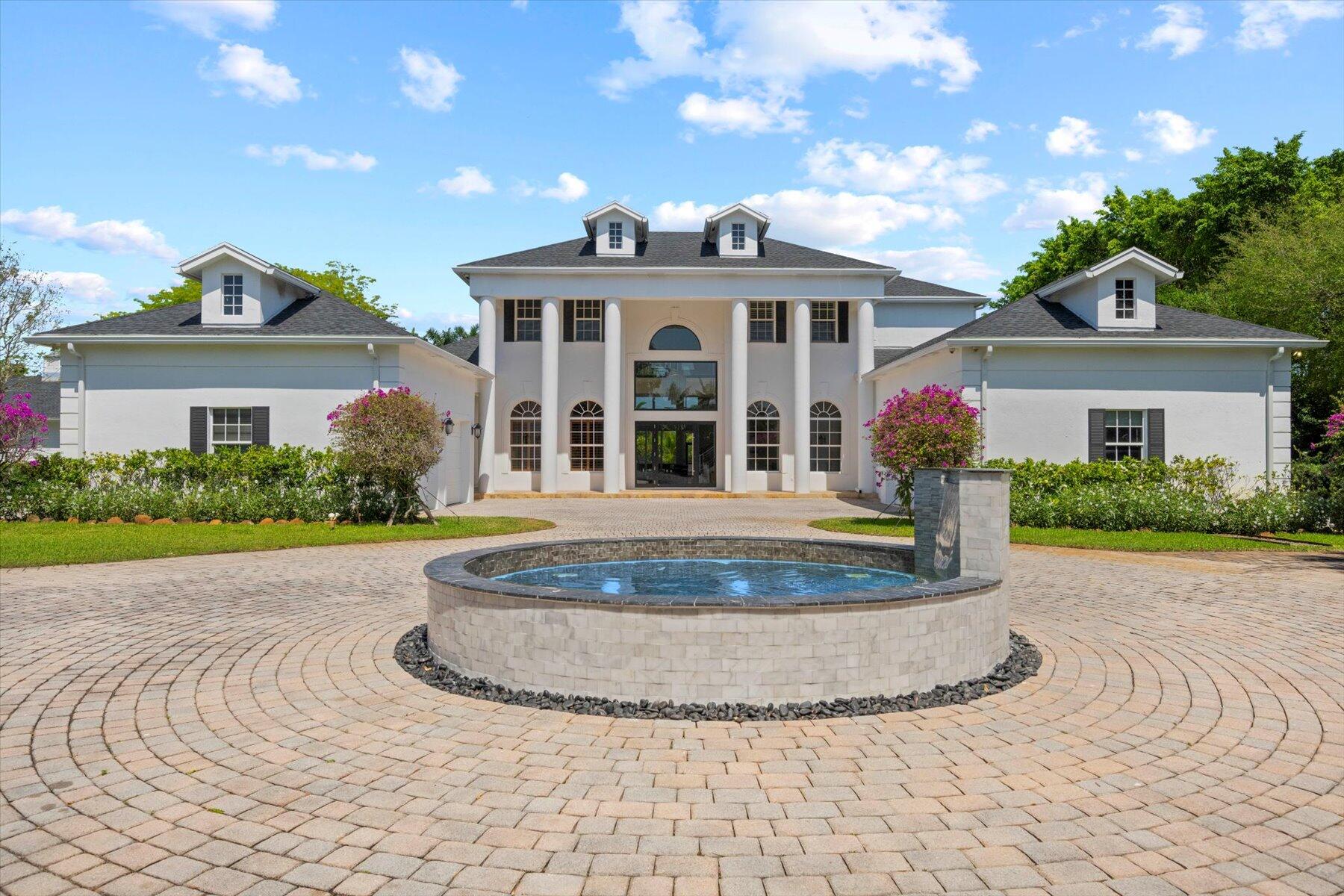 Welcome to your dream retreat in Southwest Ranches, Florida! Tucked away and gated at the end of a private road, this pristine estate sprawls across 2 acres of lush, manicured land, offering unparalleled privacy and luxury. This magnificent residence boasts 7 bedrooms and 6 full baths along with 2 half bathrooms in the main residence, providing ample space for both relaxation and entertainment. With over 7,000 square feet of living space, every corner of this home exudes sophistication and comfort. Primary bedroom is located on a private wing on the ground floor, 2 walk in closets and spa like bathroom. Living area allows you to experience the seamless blend of indoor-outdoor living. The expansive floor plan offers a movie theater, private office, wood burning fire place. A gourmet kitchen with Viking appliances and oversized island. The elegant staircase takes you to the second story where you will find 6 bedrooms and 4 full bathrooms. transitioning outside you will find a screened in patio boasting high ceiling leading to the outdoor oasis, where a sparkling salt water heated pool awaits. In addition to the main residence, a charming barn has been transformed into a one-of-a-kind music studio and full-size gym, offering a unique blend of creativity and wellness, equipped with top-of-the-line equipment and amenities including a sauna. Experience luxury living at its finest in Southwest Ranches. Don't miss your opportunity to own this extraordinary estate and make it your own private sanctuary. Schedule a showing today and prepare to be captivated by all that this remarkable property has to offer.