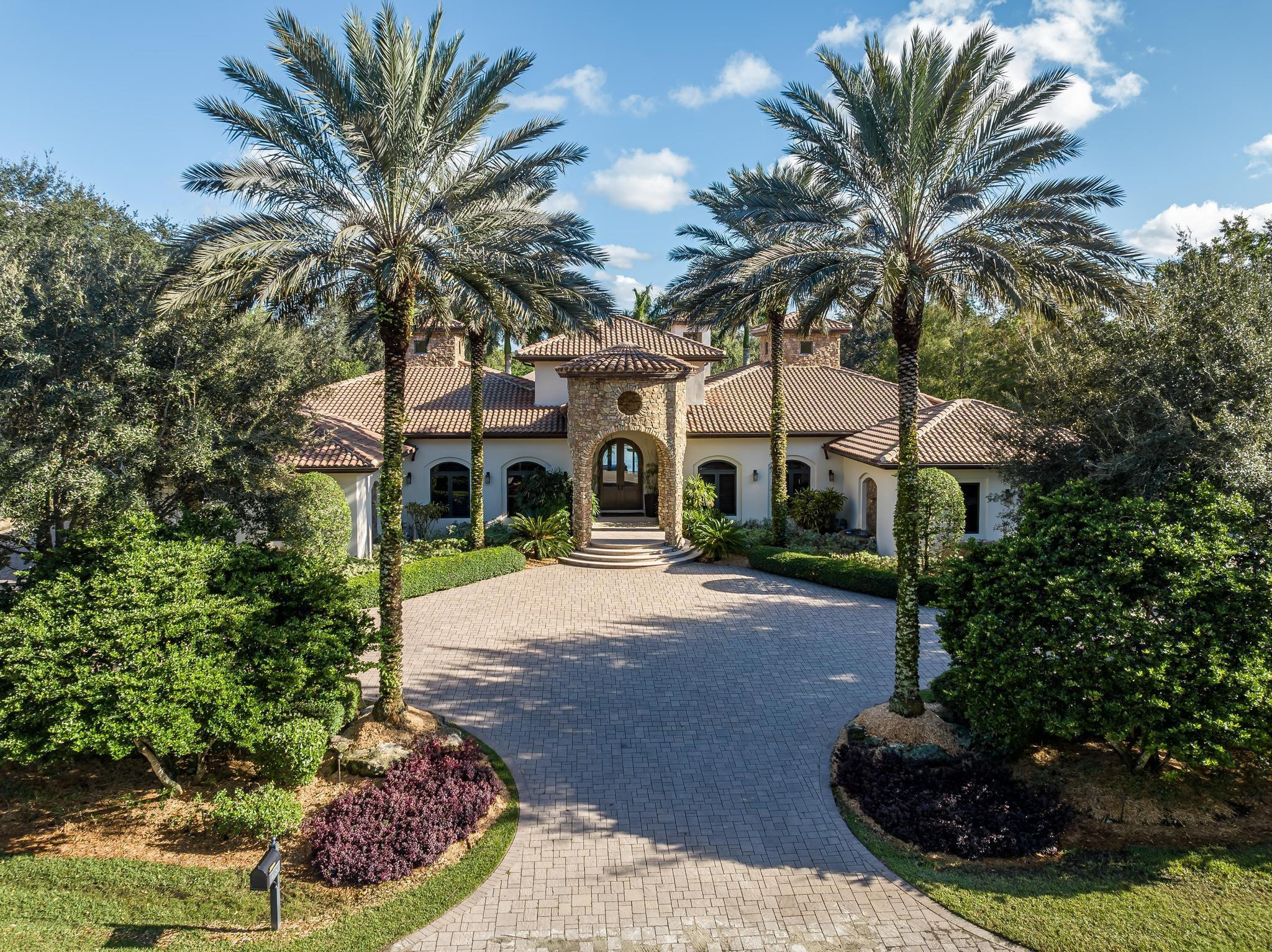 Stunning architectural design by Danny Sorogon fuses contemporary, modern and understated elegance all-in-one. One-story masterpiece spans 1.4 lakefront acres, boasting 10,553SF (8,005UA), 6BR/8BA, office, media and gym. A captivating foyer opens to dramatic views of the 40x20 pool. Interior spaces include a chef’s dream kitchen, Zen-like Owner's Suite with spa-style bath & closets, glass enclosed gym, and all ensuite secondary bedrooms. The resort-style estate utilizes master craftsmanship, dark woods and abundant natural light, carefully woven with crisp contrasting colors, creating a relaxed vibe, all while remaining tech-forward with an engaged Crestron (Smart Home) system allowing for complete control. A family compound where memories are made and living your best life is celebrated.