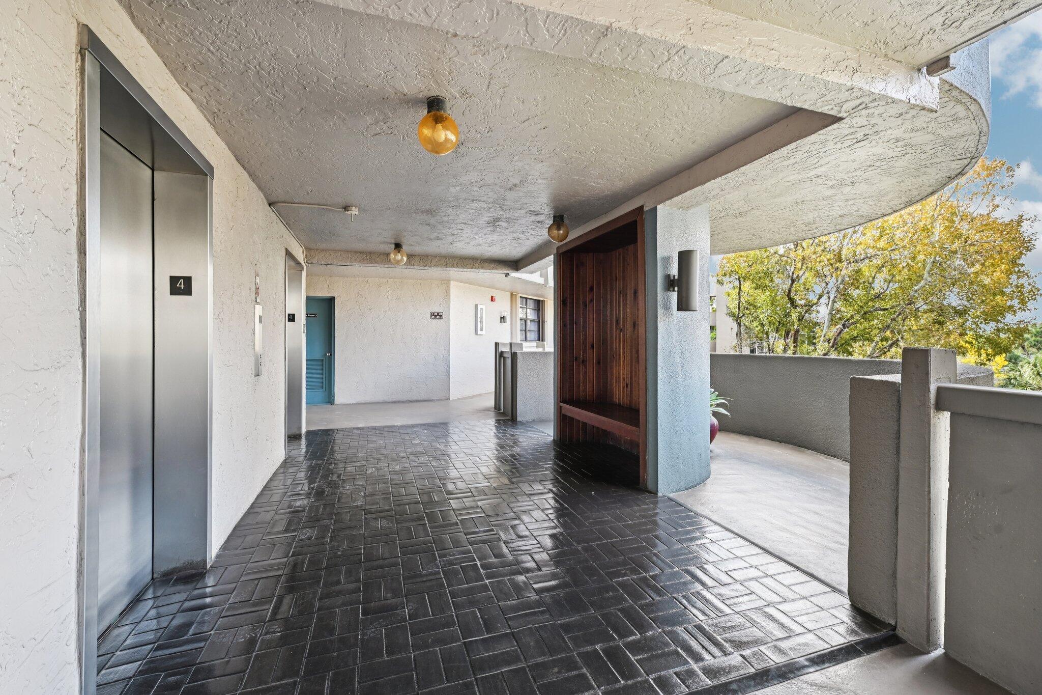 Lovely one bedroom with large den/guest area and two full bathrooms with screened balcony overlooking a beautiful, serene lake.  55+ community with guard gated security.  The kitchen and second bathroom have been upgraded with new cabinets and stainless steel appliances. New carpeting. There is a storage room just around the corner with a large storage area for every unit. Washer and dryer is in the unit. Roll-down shutters on the balcony. There is an elevator in the building. Enjoy resort-style amenities including a clubhouse, heated pool, jacuzzi, tennis, racquetball, billards and a courtesy bus. HOA includes water, cable, internet, building maintenance, roof, common area and all amenities. No pets or leasing is allowed. MOTIVATED SELLER - WILL PAY 3 MONTHS OF HOA FEES AT CLOSING. PARKING SPACE NUMBER IS #41