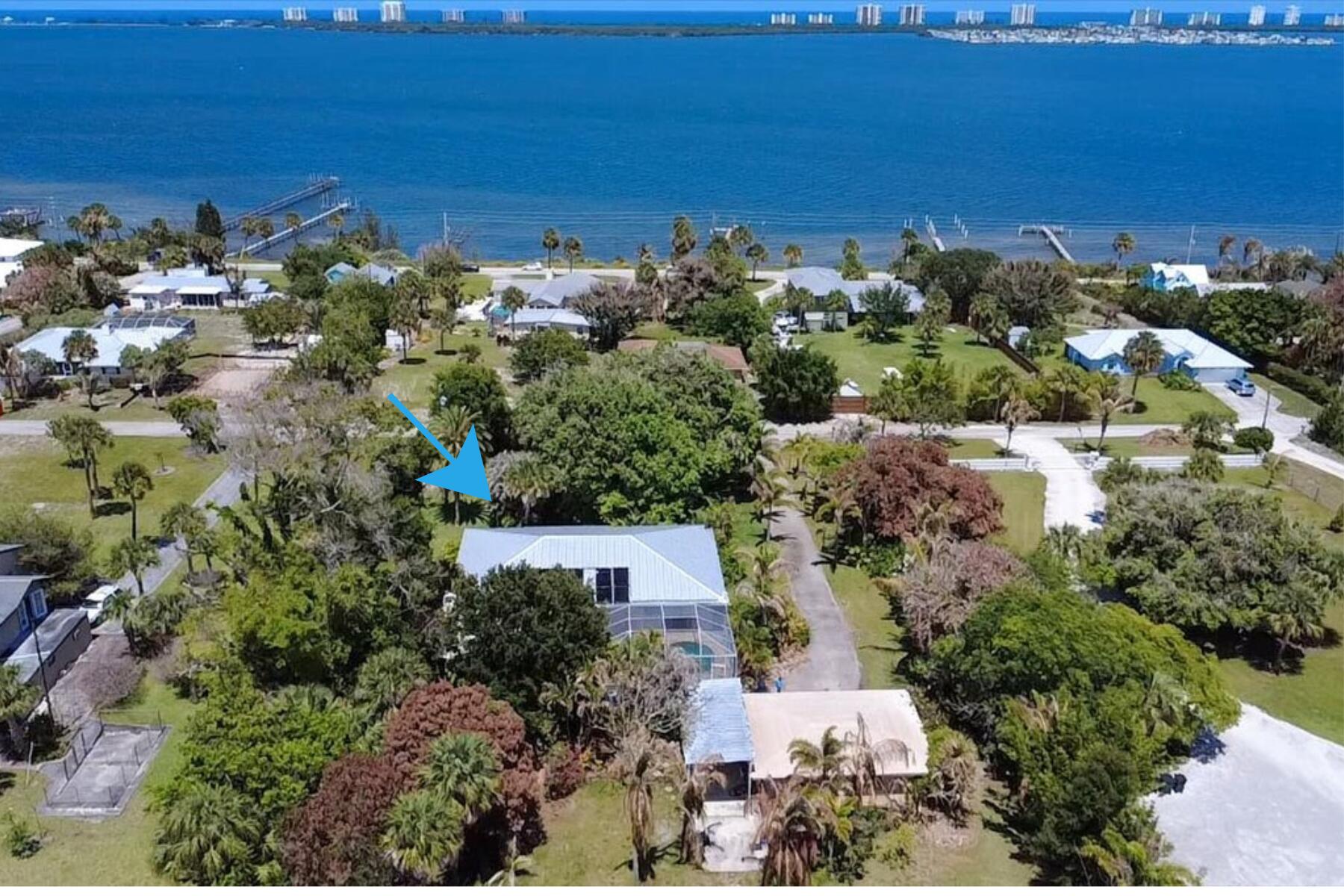 Welcome to 105 Sheridan Lane! Situated on 1.87 acres just one block from the Intracoastal Waterway, this beautifully maintained 3BR/4BA estate offers over 3,200 SF of living space along scenic Indian River Drive. Positioned at over 30 feet of elevation in Flood Zone X, enjoy peace of mind, ocean breezes, and partial views of the Intracoastal and Savannahs. Features include a spacious family room with wood-burning fireplace, eat-in kitchen with wet bar and antique stove, private primary suite with pool access, sunken tub and walk-in closet, screened pool, detached 2-car garage, workshop, RV carport with hookups, two wells, and two septic systems. Minutes from beaches, boating, fishing, shopping, and dining. Priced over $100,000 below market value. Don't miss this exceptional opportunity.
