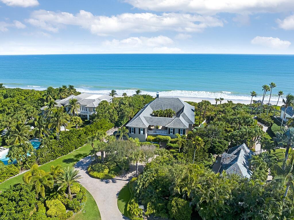 Oceanfront Elegance in coveted Bermuda Bay! Rare opportunity in guard-gated enclave just minutes from the island's best boutiques & dining. Enjoy total privacy on nearly an acre at end of quiet cul-de-sac. This Peter Moor designed estate offers direct beach access & stunning views. Built by Croom Construction, the home features a spacious great room, 4 ensuite bedrooms, custom library/office, chef's kitchen w/ adjoining family room, and lower-level media space with kitchenette & full bath--ideal for entertaining or overflow guests. Sizes are approx/subj to error.
