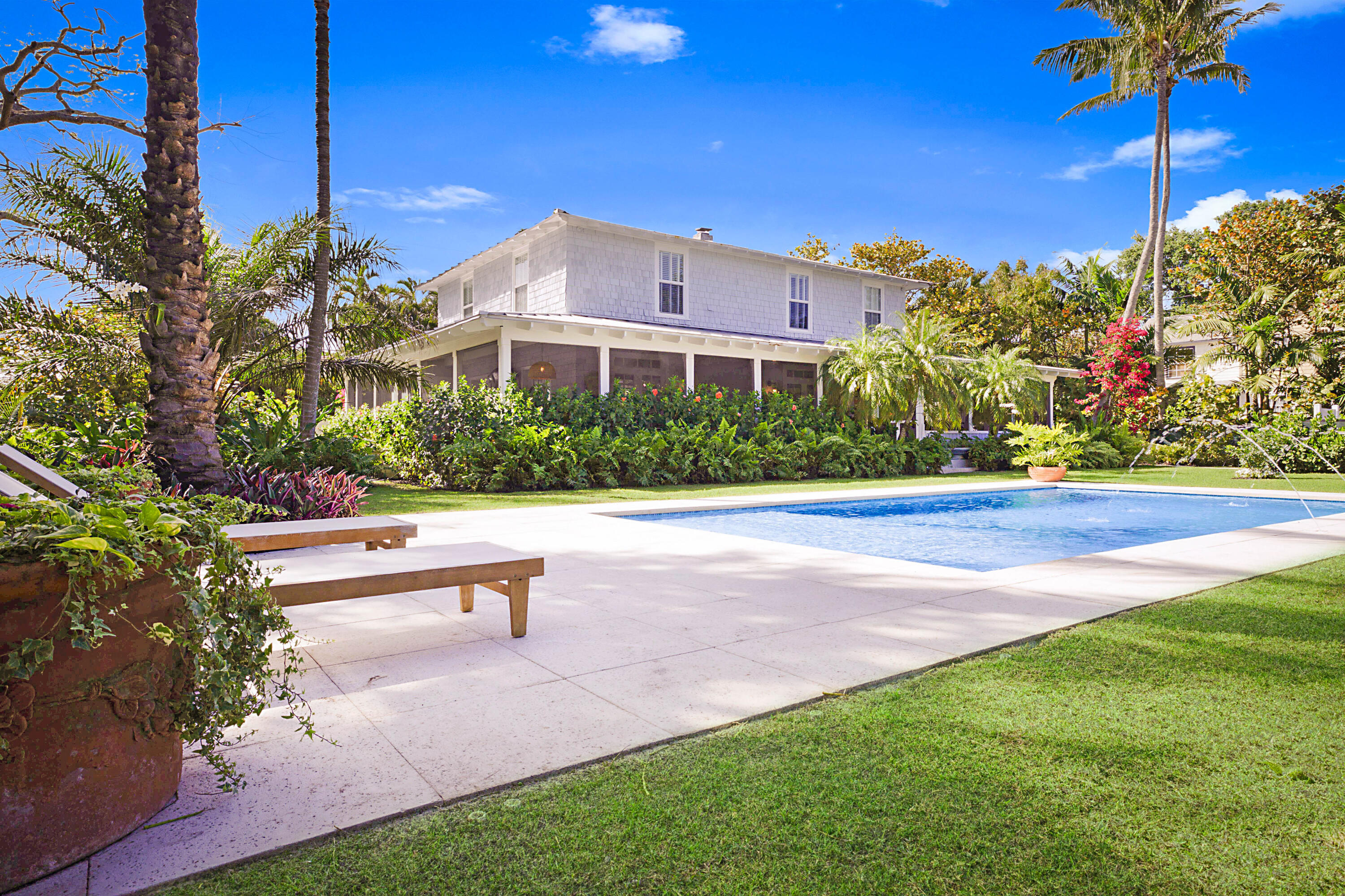 Welcome to 3402 Floral Ave, a stunning Montauk style 4bedroom 4bath home tucked away on a tranquil estate size lot a block from N Flagler in the coveted Northwood Shores neighborhood. This home has just been meticulously renovated while retaining its history and charm with all the modern conveniences. Updates include high end finishes through with marble baths, chef's kitchen, bar area, impact windows,HVAC,electrical and plumbing updates. The property has been extensively landscaped and thoughtful outdoor lighting has been installed. The original design of the first floor boasts a light filled space with a bank of 4 sets of French doors leading out to a 1100 square foot wrap around screened porch. Main level has original Dade County Pine floors, a wood burning fireplace, and a guest room/ office. 3 bedrooms and 3 full baths are located on 2nd floor. The Lush landscaped yard is complimented by a 15 x 30 inground pool with southeast exposure. A 2-car gated driveway, barbeque area and outdoor living area with a fireplace complete this truly special lot. If you are looking for a one-of-a-kind home with the luxury of land and privacy in the city this is for you. Less than 3 miles to downtown WPB, 2 miles to the north Bridge and palm beach Island and a 15-minute commute to PBI Airport.