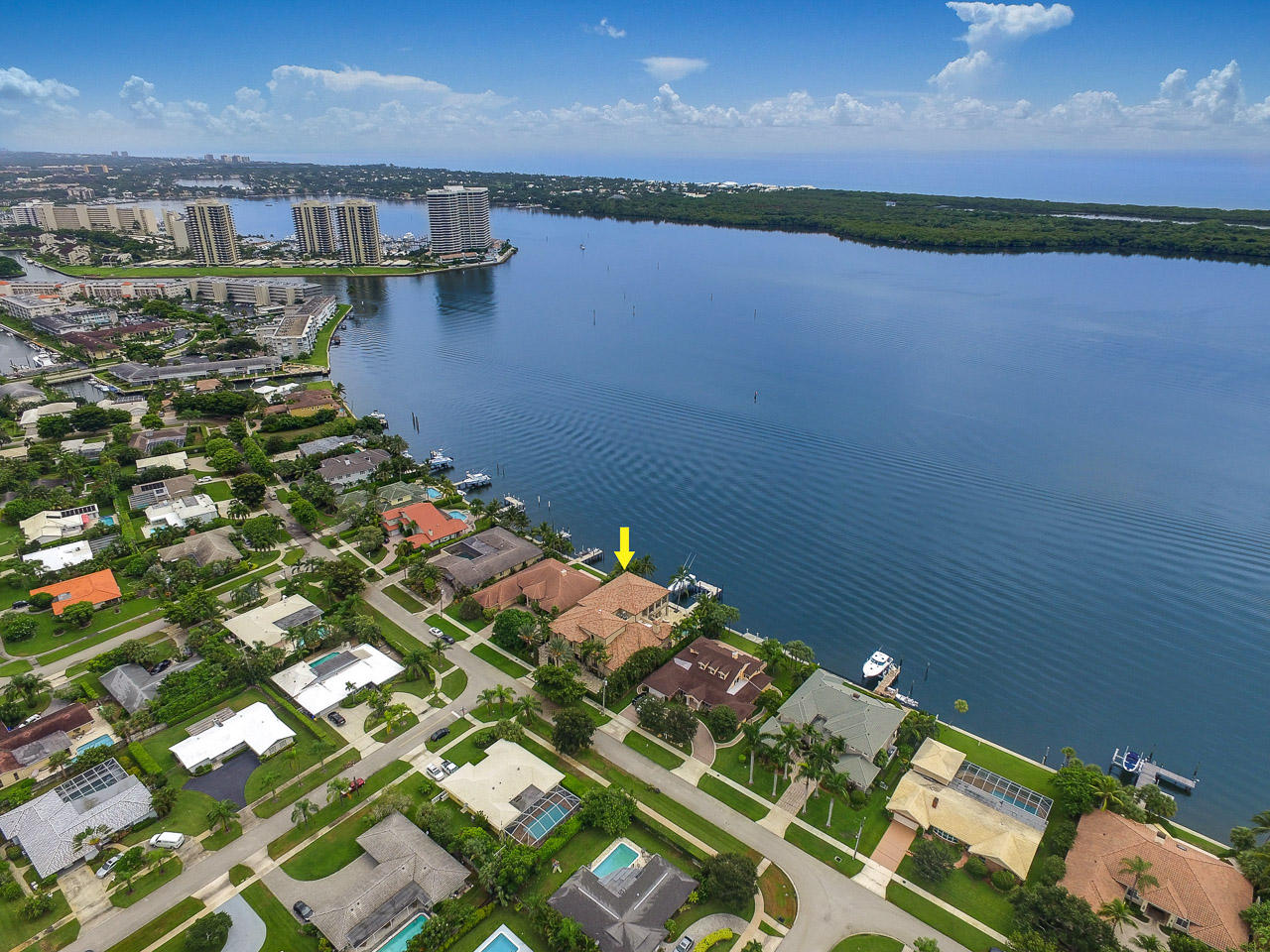 Waterfront Estate with 11,000 square feet and endless views of Lake Worth. Attention to every detail is evident wherever one looks. Enjoy wide water Intracoastal views. The first floor master bedroom has Brazilian Walnut flooring, a separate sitting room with a fireplace, separate his and hers bathroom suites, Italian Onyx wall ''lighted'' paneling, Onyx vanity tops, two story her walk-in closet and a fireproof vault room with security protection, poured concrete walls and ceiling and a built-in jewelry cabinet. The office has a Bamboo accent tray ceiling and Burlwood marble tops from India. The Gourmet kitchen has double dishwashers, a double wall oven, Dacor gas cooktop, custom cabinets and granite counter-tops. Other features include impact doors and windows, Turkish stone flooring, all new Bryant air-conditioners, new 100KW Kohler whole home generator, 1500+ bottle climate controlled wine room with slate flooring, large loggia containing a summer kitchen with a 42" pizza oven & built-in gas grill and climate controlled 4 car garage. The tiled concrete dock is equipped with 26,000lb and 5,000lb boat lifts, a filet table and two power pedestals.