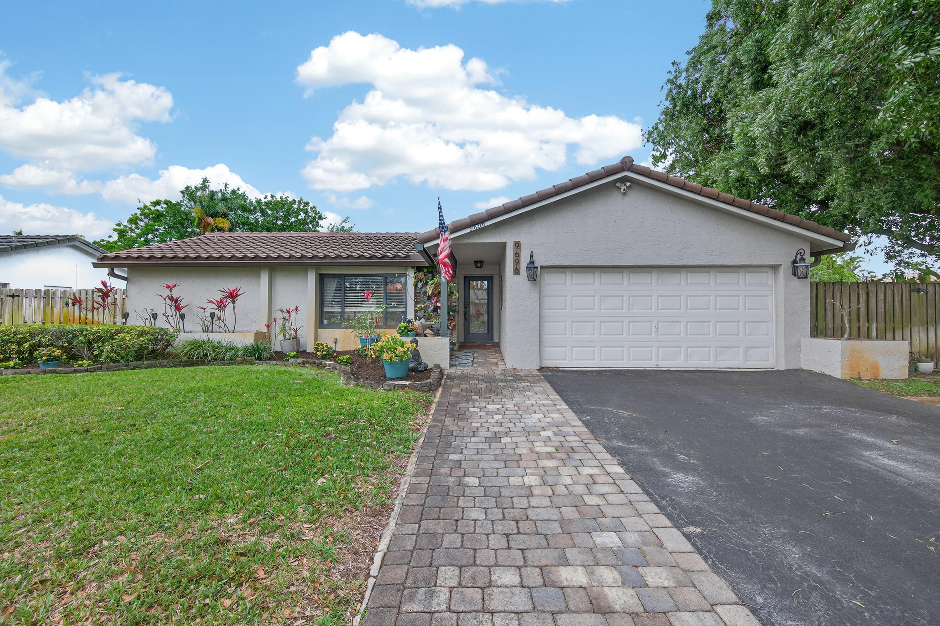 2023 Roof! 2025 AC! 2022 Impact Windows! 2023 Gutters with Leaf Guard! 2022 14x18 Tiki Hut! Located on a corner lot. This 3-bedroom, 2-bath home offers 1,652 square feet of comfortable living space with a layout designed for both everyday living and entertaining. The home features two separate living areas one with a cozy wood-burning fireplace, and the other features a glass enclosed cabinet that can be used also for a wine collection, simply perfect gathering spaces. The updated kitchen is equipped with granite countertops, stainless steel appliances, a pantry, and a large island with seating, along with direct access to the screened lanai. The split-bedroom floor plan provides added privacy, and both bathrooms have been updated.  The primary suite offers a private retreat with a custom walk-in closet and an updated bathroom featuring a tub and glass-enclosed shower, while the primary bedroom also provides direct access to the screened lanai. Outdoor living is just as impressive, with a 14x18 tiki hut perfect for entertaining, a beautifully landscaped yard with a winding stone pathway, and a doggie pool with a deck, plus additional space to relax and enjoy the peaceful setting. Conveniently located just a few miles from Parkside Elementary School, Mullins Park, Coral Springs Center for the Arts, the post office, restaurants, and Coral Springs Medical Center. Don't wait—call today to schedule your private showing!
