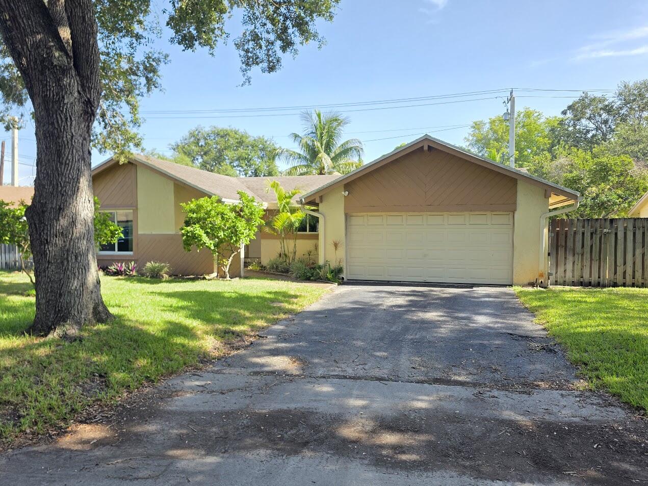 Rock Creek Gem sitting on 9,600 sqft lot.  This three-bedroom, two-bathroom home offers 1,629 square feet of finished living space and a 2 car Garage.  Featuring  Very Large yard with oversized in ground pool, Mango Trees, Avocado Tree, Coconut Trees, Banana Trees,  great for entertaining, Impact windows and doors 2023, AC replaced in 2017, Roof replaced in 2019. Add your personal touches to this hidden gem! Wont Last at this Price.