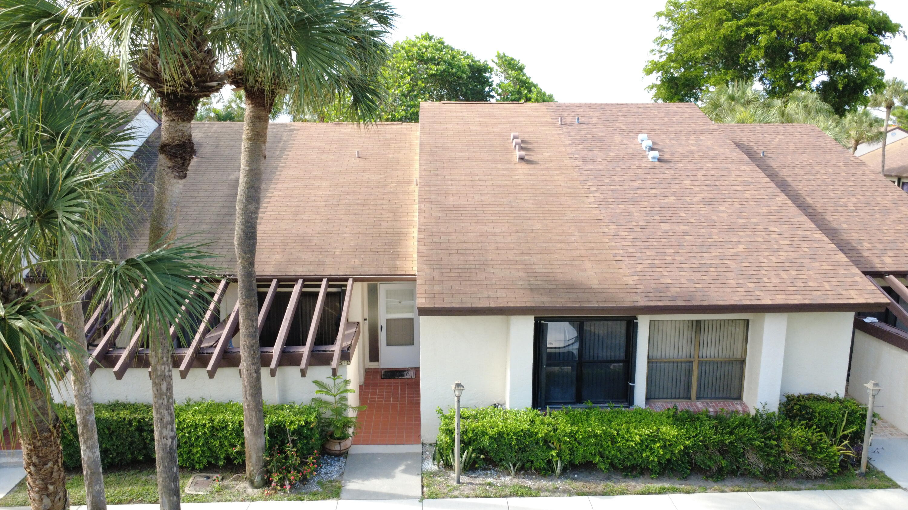 Move right into this beautifully maintained 55+ villa featuring a newer kitchen, soaring vaulted ceilings, and a spacious open layout filled with natural light. Enjoy year-round indoor/outdoor living in the large glass-enclosed patio, perfect for relaxing, entertaining, or creating additional living space. Major updates provide peace of mind, including a 2020 roof and 2023 A/C. This move-in-ready home offers a blend of comfort, style, and convenience in a desirable location just minutes from Florida's Turnpike, shopping, dining, parks, and everyday amenities. Don't miss this opportunity to own a well-maintained home in a unbeatable location. .