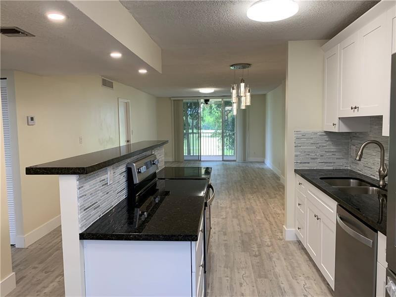 RARE FIND! COMPLETELY REMODELED! AMAZING VIEW TO GOLF COURSE AND LAKE! KITCHEN WITH NEW WOOD CABINETS,GRANITE COUNTER TOPS, NEW HI-END WHIRLPOOL APPLIANCES, REFRIGERATOR FEATURING FILTERED ICE AND WATER. OVERSIZED GREAT-ROOM AND DESIGNER LIGHTING. LOCATED ON THE EXCLUSIVE JACARANDA GOLF AND COUNTRY CLUB IN A VERY PEACEFUL ENVIRONMENT. INCLUDED IS A LAUNDRY FACILITY WITH NEW APPLIANCES AND RECHARGEABLE CARD SYSTEM, STORAGE ROOM, HEATED COMMUNITY POOL, RECREATION ROOM AVAILABLE FOR PARTIES. AC IS 2024. GREAT FOR INVESTORS. UNIT IS RENTED TO GREAT TENANTS